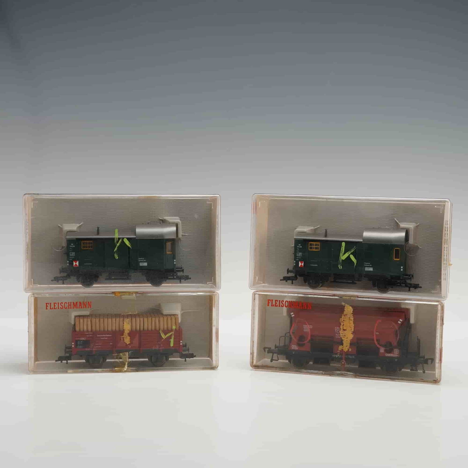 4pc Fleischmann HO Gauge Freight Cars, 5301, 5301, 5510, 5203: This lot consists of four Fleischmann HO scale freight cars, each housed in its original clear plastic case with printed inserts and red instruction panels on the reverse. The group includes two