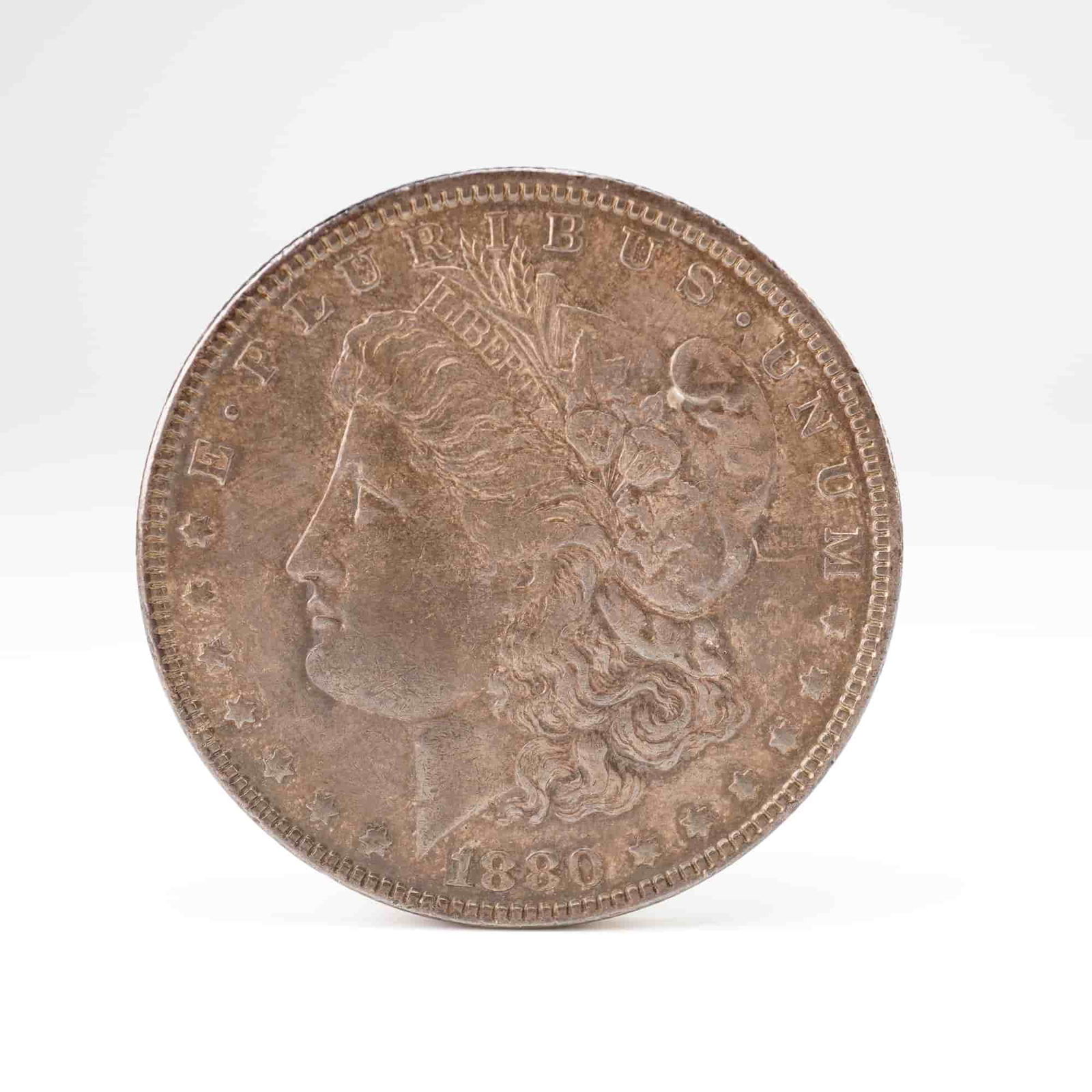 US 1880 Morgan One Dollar Coin, Silver, KM# 110, Very Fine: KM# 110. Philadelphia Mint (no mint mark). Morgan Dollar design type. This 1880 U.S. Morgan One Dollar Coin features a reeded edge. The 1880 Philadelphia mintage is a common date within the series