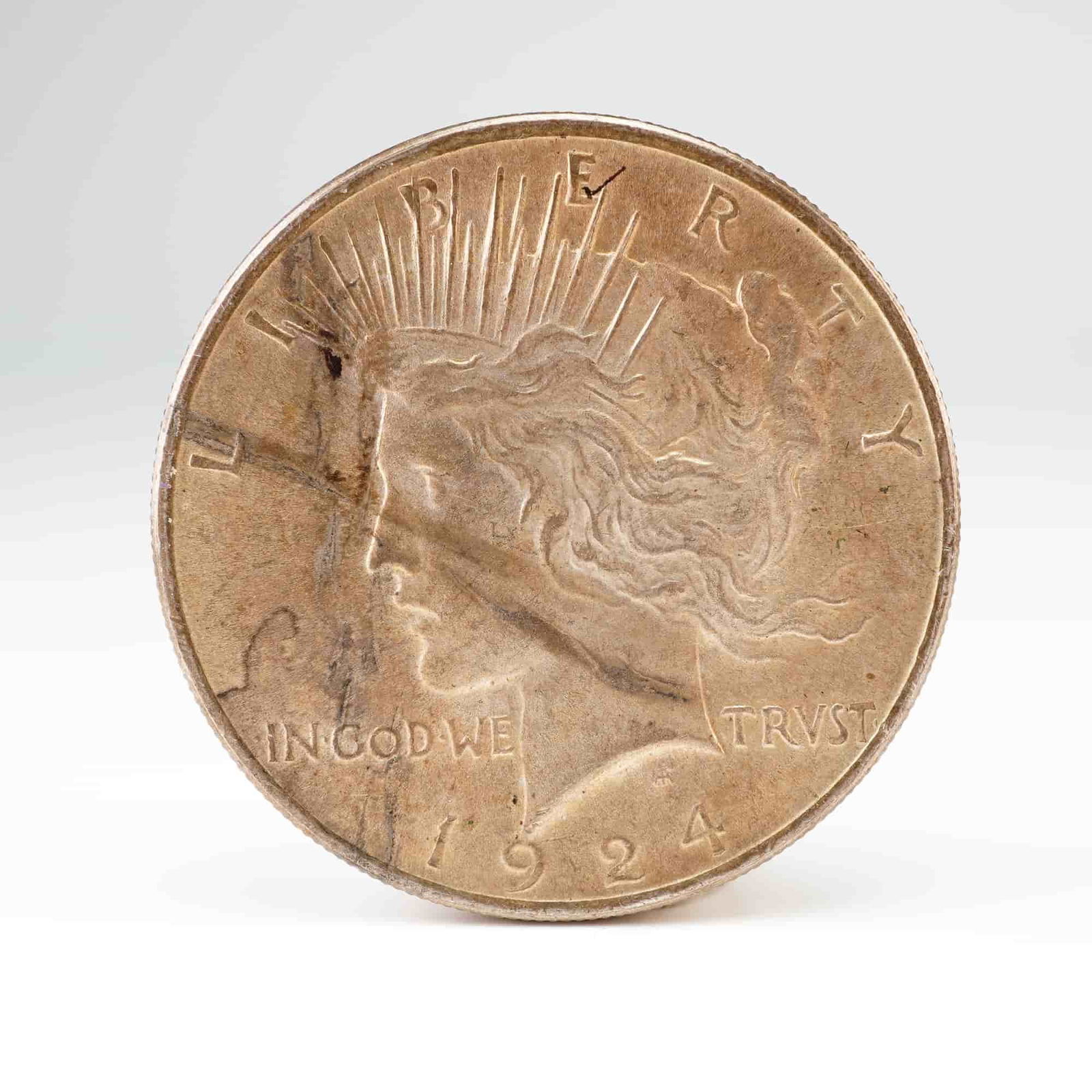 US 1924 Peace Dollar, Silver: KM# 150. Philadelphia Mint. Peace Dollar type. This 1924 U.S. Liberty One Dollar Coin features a reeded edge. The 1924 Philadelphia issue is a common date within the series with a mintage exceeding