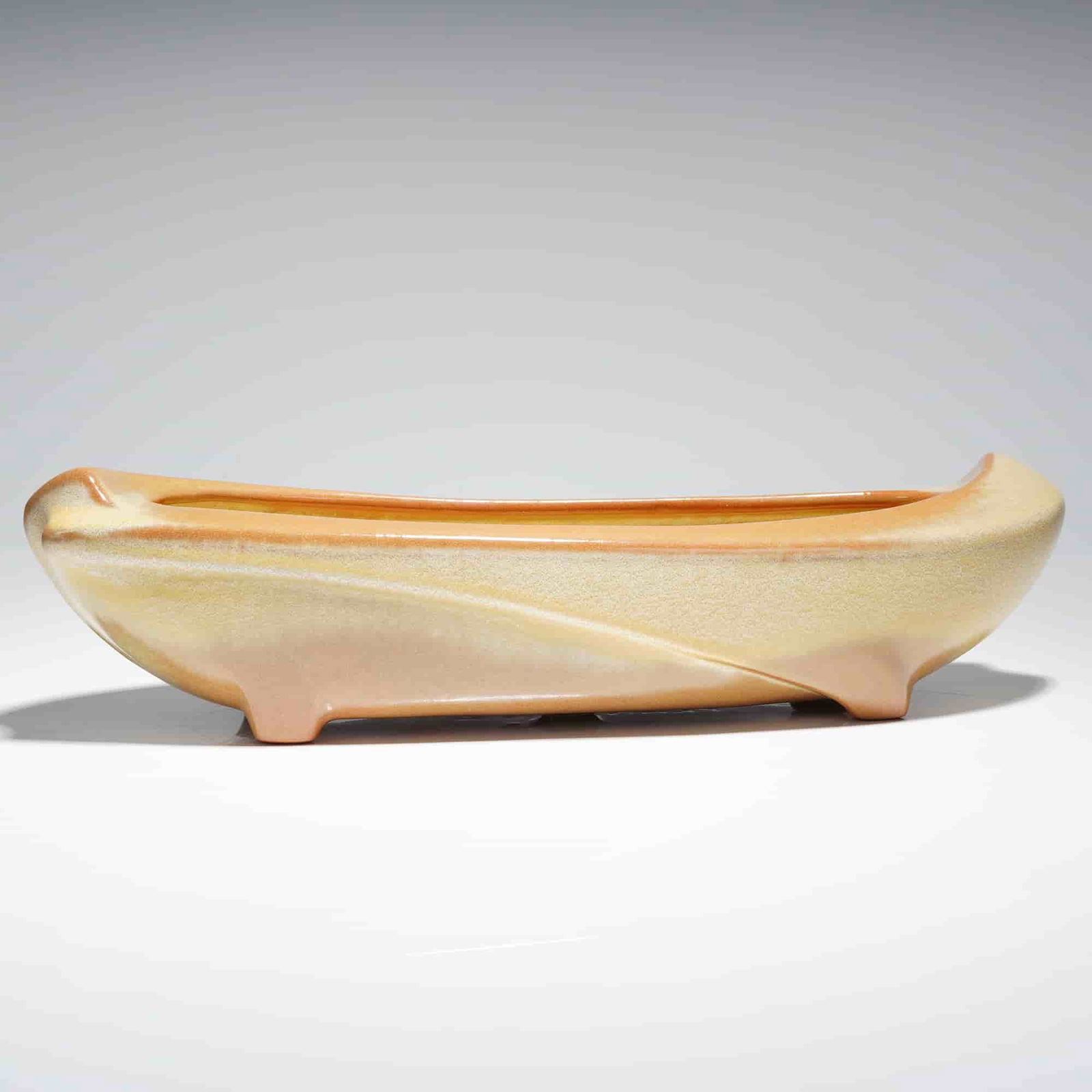 Frankoma Pottery Mid-Century Modern Ceramic Planter Bowl Model 45: A single elongated, boat-shaped ceramic planter or shallow dish produced by Frankoma Pottery, executed in a Mid-Century Modern style. The piece is identified by the impressed mark as Model 45. The ext