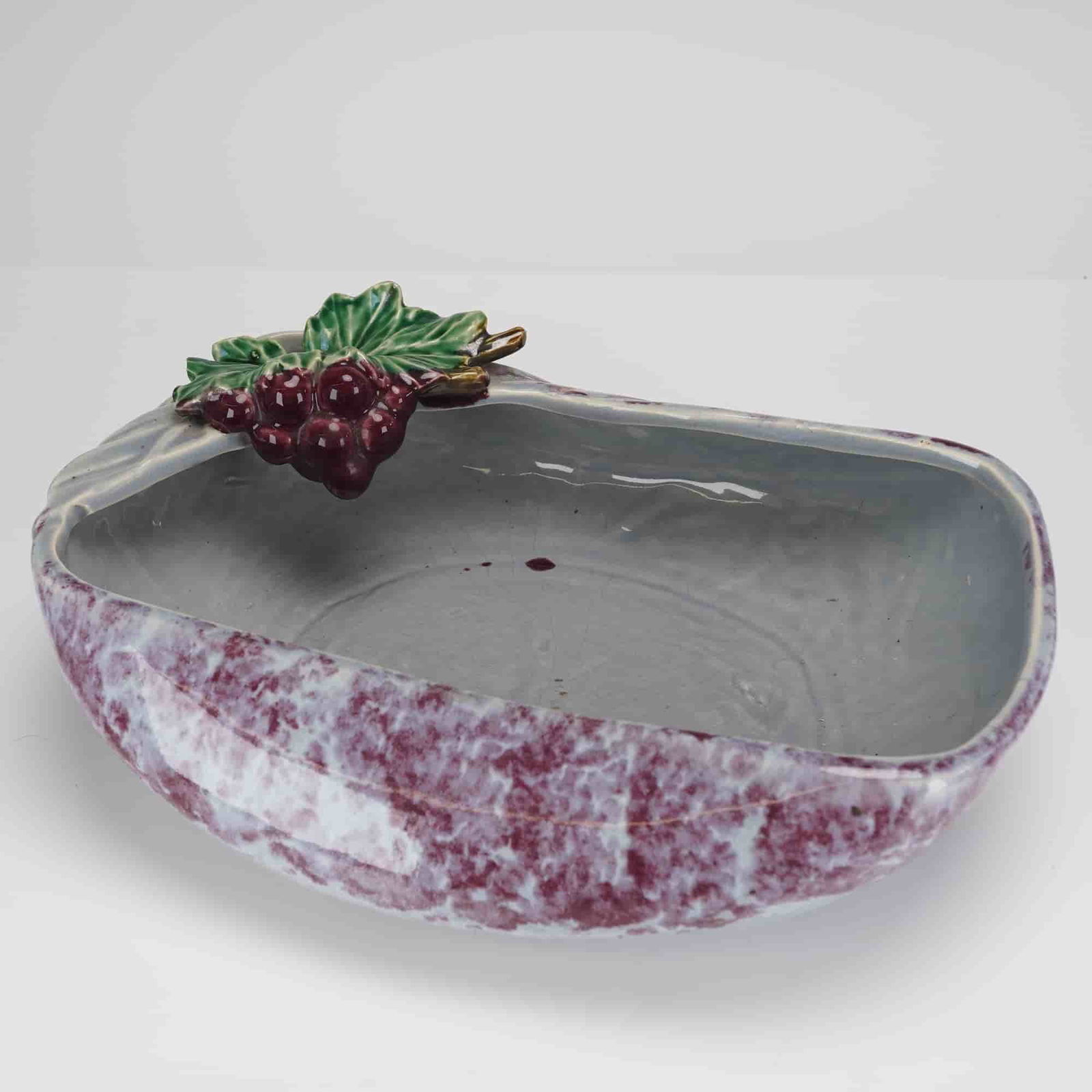McCoy Brocade Splatter Centerpiece Bowl Planter: A single elongated, asymmetrical ceramic centerpiece bowl or planter attributed to McCoy Pottery in the Brocade Splatter pattern. The exterior is finished in a mottled glaze featuring white/light