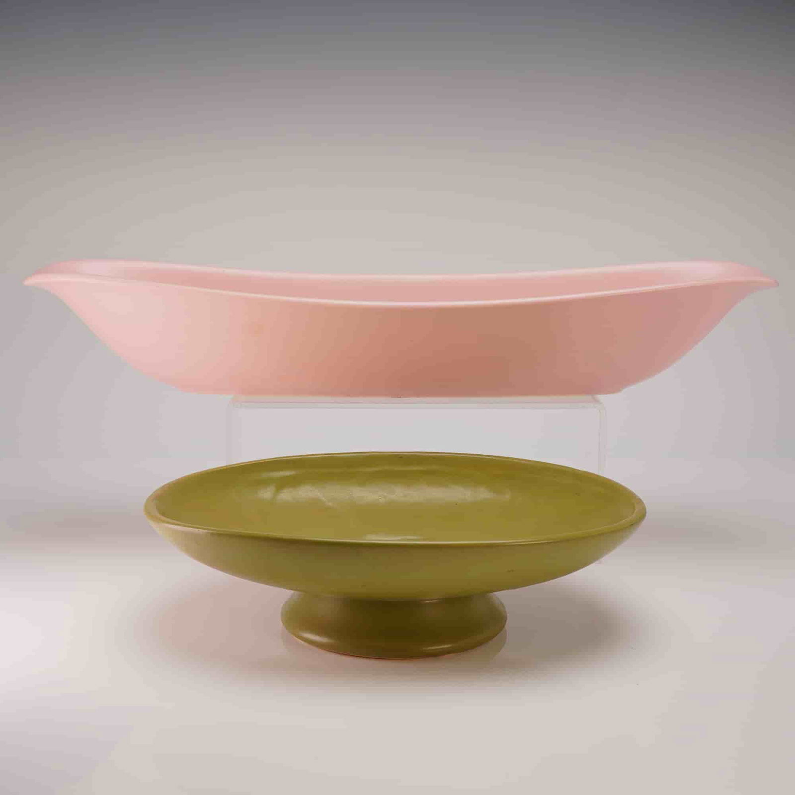 A Pair of Mid-Century Modern Ceramic Centerpiece Bowls Hyalyn and Floraline: A pair of Mid-Century Modern ceramic pottery centerpiece vessels, comprising two distinct forms attributed to two separate American manufacturers. The first vessel is an elongated, shallow,