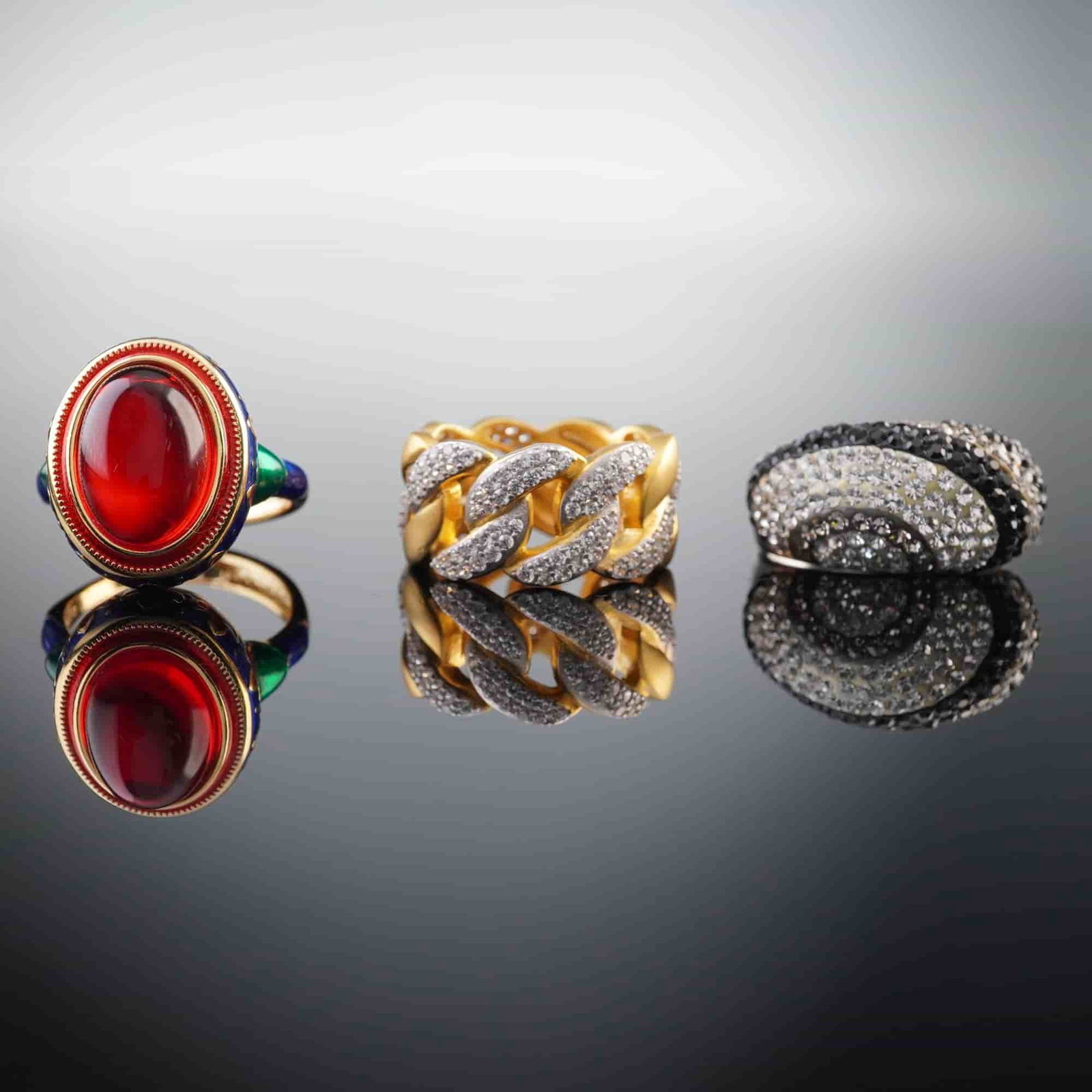 3pc Sterling Silver Statement Ring Set with Crystal & Enamel Accents: This set includes three beautiful rings, each crafted from sterling silver. The first ring features a bold gold-tone design with clear crystal accents. The second showcases a striking black and clear