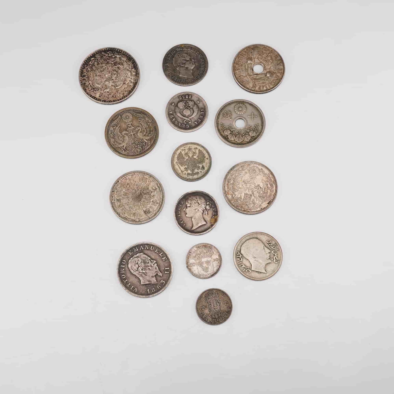 14pc Global Assorted Coins: including a Japanese 50 sen coin with chrysanthemum crest and floral wreath designs with inscriptions in Japanese; a Japanese 10 sen coin with central hole, floral border, and Japanese inscriptions; a