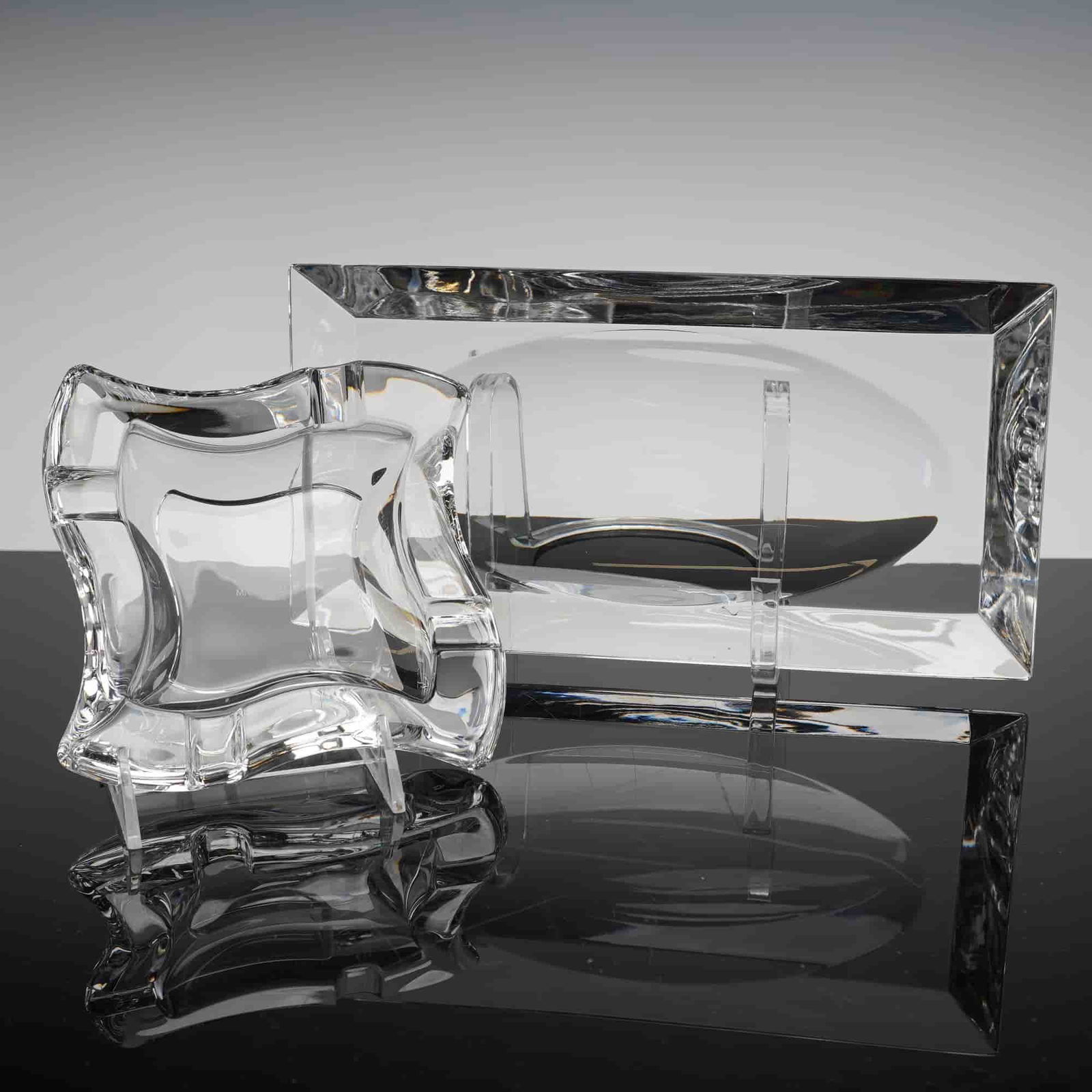 A Pair of Christofle and Marc Aurel Crystal Trays: A two-piece lot consisting of a Christofle cristal tray and a Marc Aurel crystal ashtray. Both pieces are marked on the base. The first item, attributed to Christofle, is a solid, rectangular block