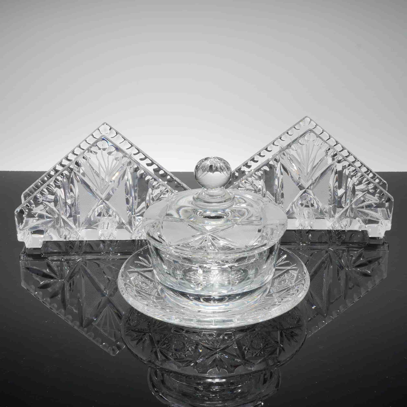 3pc Czech Republic Crystal Napkin Holders and Jewelry Box: A collection of three pieces of clear, hand cut lead crystal. The group consists of two matching triangular napkin holders and one covered jewelry box with a fitted lid topped by a spherical finial.