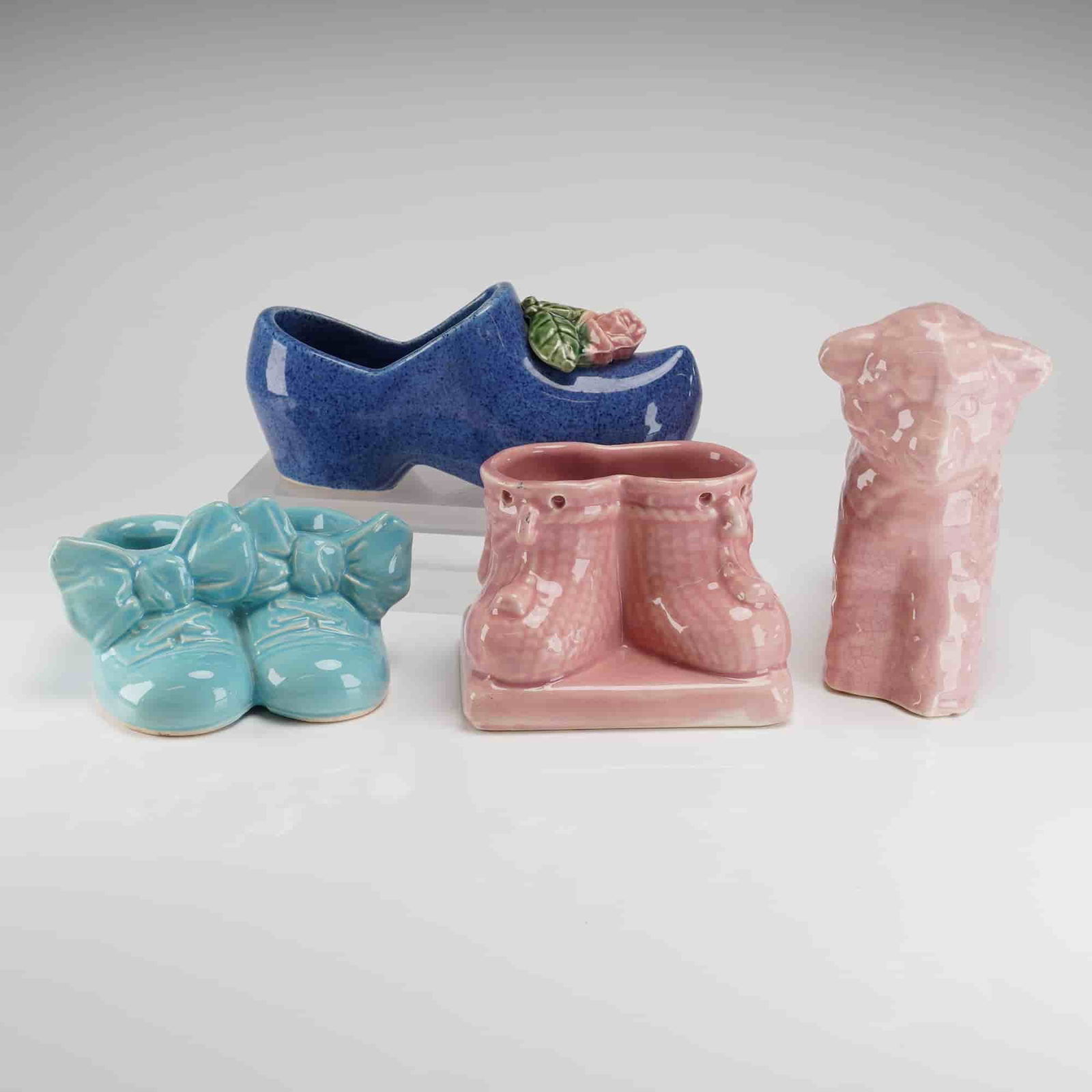 A Collection of Four McCoy and Cameron Clay Pottery Planters: A collection of four novelty ceramic planters, attributed primarily to McCoy Pottery, with the possibility of inclusion of Cameron Clay Pottery pieces, dating to the mid-20th Century. The group