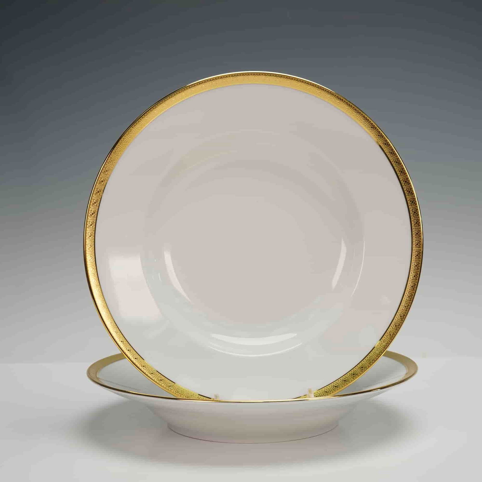 2pc Richard Ginori Gilt Trim Soup Bowls: Featuring a white ground accented by an elegant, wide gilt rim, each bowl displays a smoothly contoured, gently curved interior designed for refined service. The exterior maintains clean, balanced lin