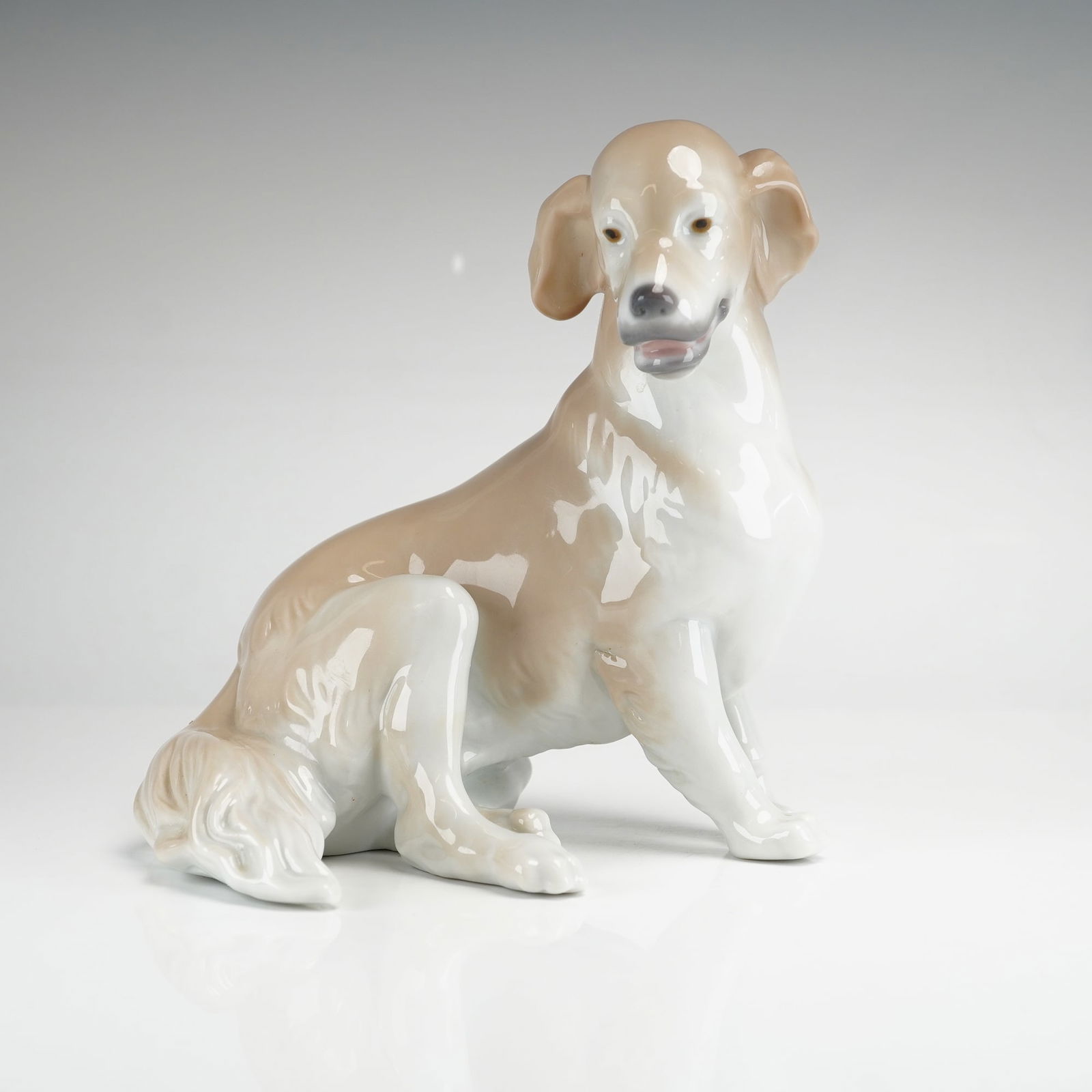 Lladro Golden Retriever Porcelain Figurine, Model 8345: A Lladro glazed porcelain figurine of a Golden Retriever, model number 8345. The dog is modeled in a seated, alert position with a naturalistic expression. The color palette consists of a cream-colore