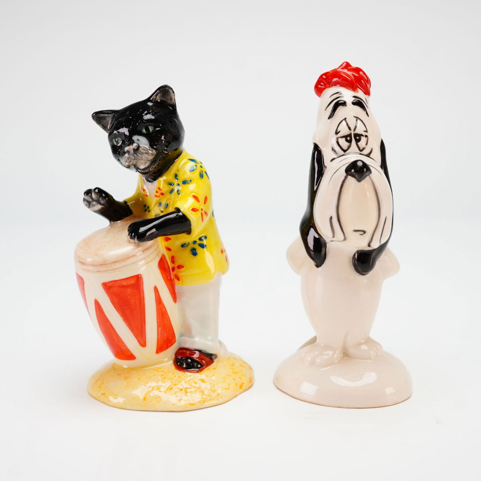 A Pair of Beswick Porcelain Figurines, Calypso Kitten and Droopy: This lot features 2pc Beswick porcelain figurines including the Calypso Kitten and Droopy. The first figurine is the Beswick Calypso Kitten from the Cats Chorus series, model number CC 2. It depicts a