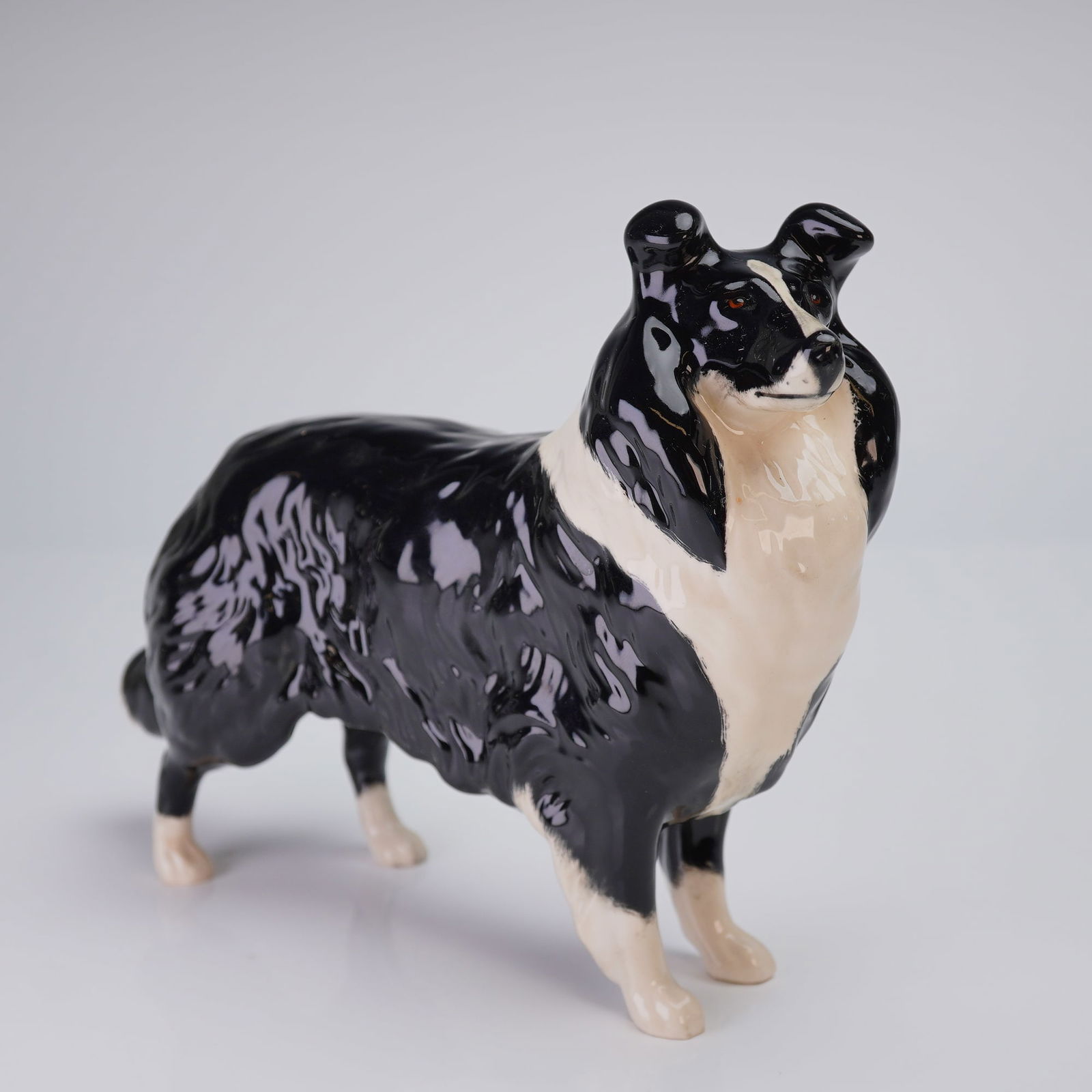 Beswick Black and White Sheepdog Figurine, Model 1792: A glazed ceramic figurine manufactured by Beswick, England, identified as Model No. 1792 (Sheepdog). The figure depicts a standing dog, characteristic of a Rough Collie or Shetland Sheepdog breed, ren