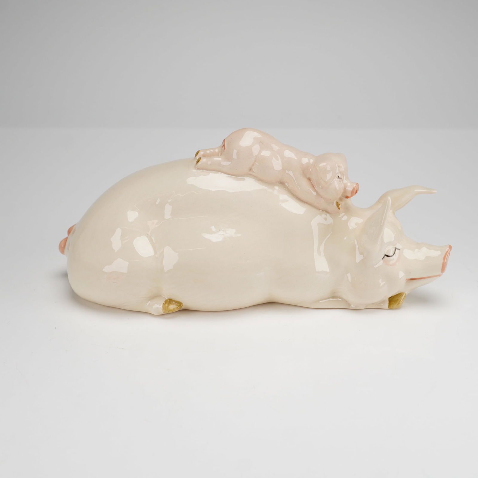 Beswick Pig and Piglet Piggyback Figurine Model Number 2746: This Beswick figurine pig and piglet, identified as the Piggyback model number 2746, is a glazed ceramic study of a sow lying on its side with a piglet resting on its back. The piece is finished in a