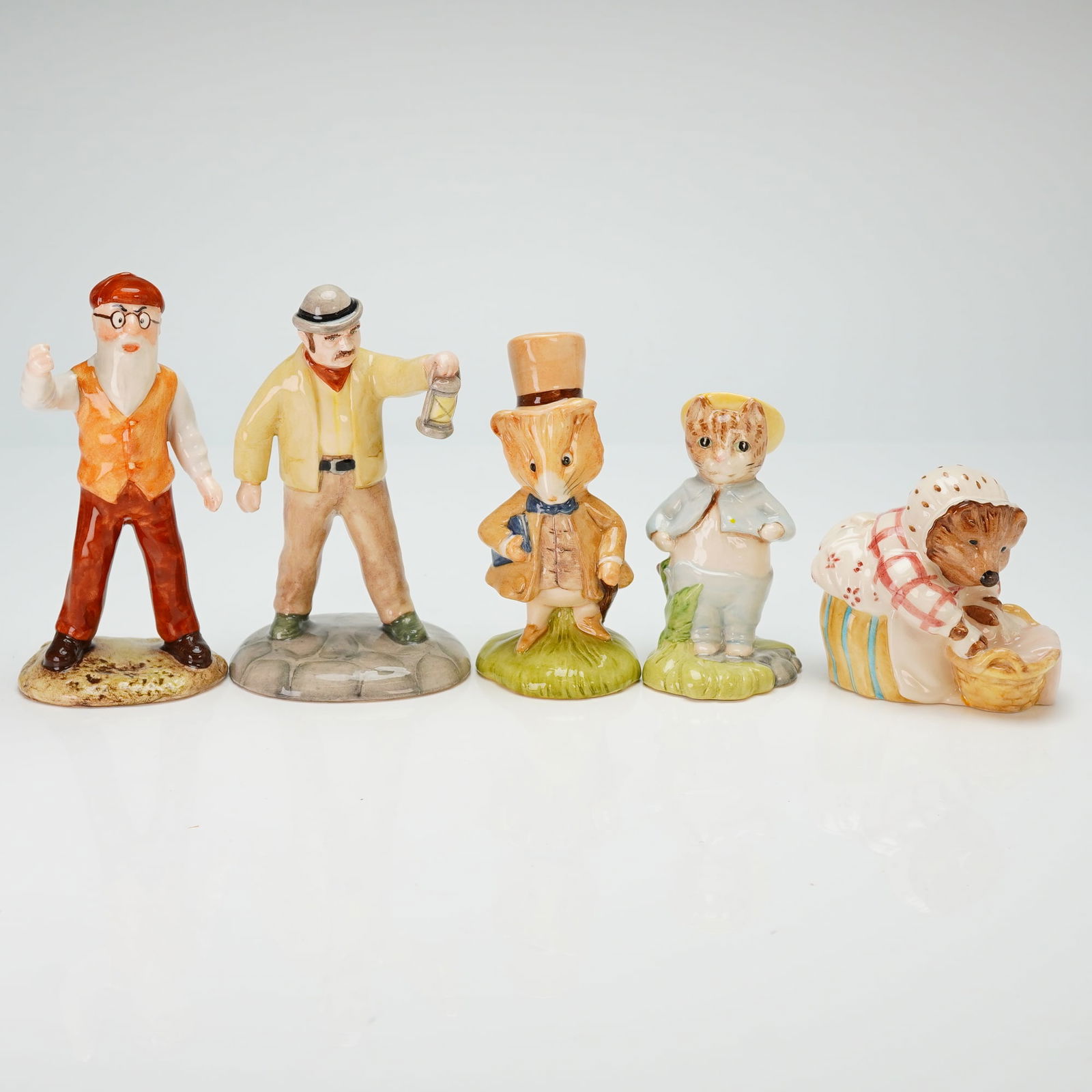 Collection of Five Beswick Beatrix Potter Ceramic Figurines: A collection of glazed ceramic figurines from the Beatrix Potter series, produced by Beswick under Royal Doulton. The group includes various characters such as Mr. McGregor, Farmer Potatoes, Amiable G