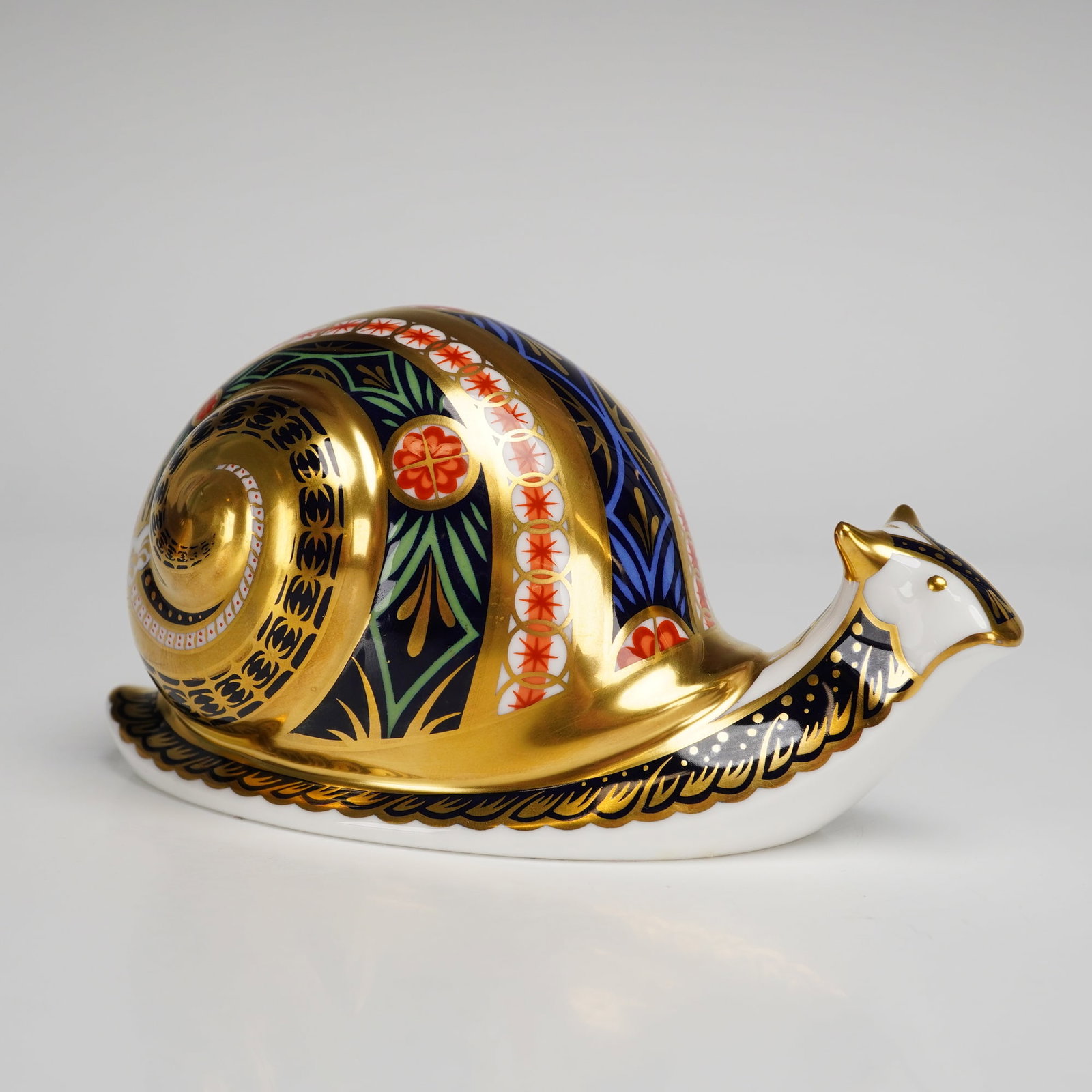 Limited Edition Royal Crown Derby Paperweight, Garden Snail: A Royal Crown Derby paperweight titled Garden Snail, part of a limited edition release. The piece is constructed from English fine bone china and decorated in the traditional Imari style, utilizing a