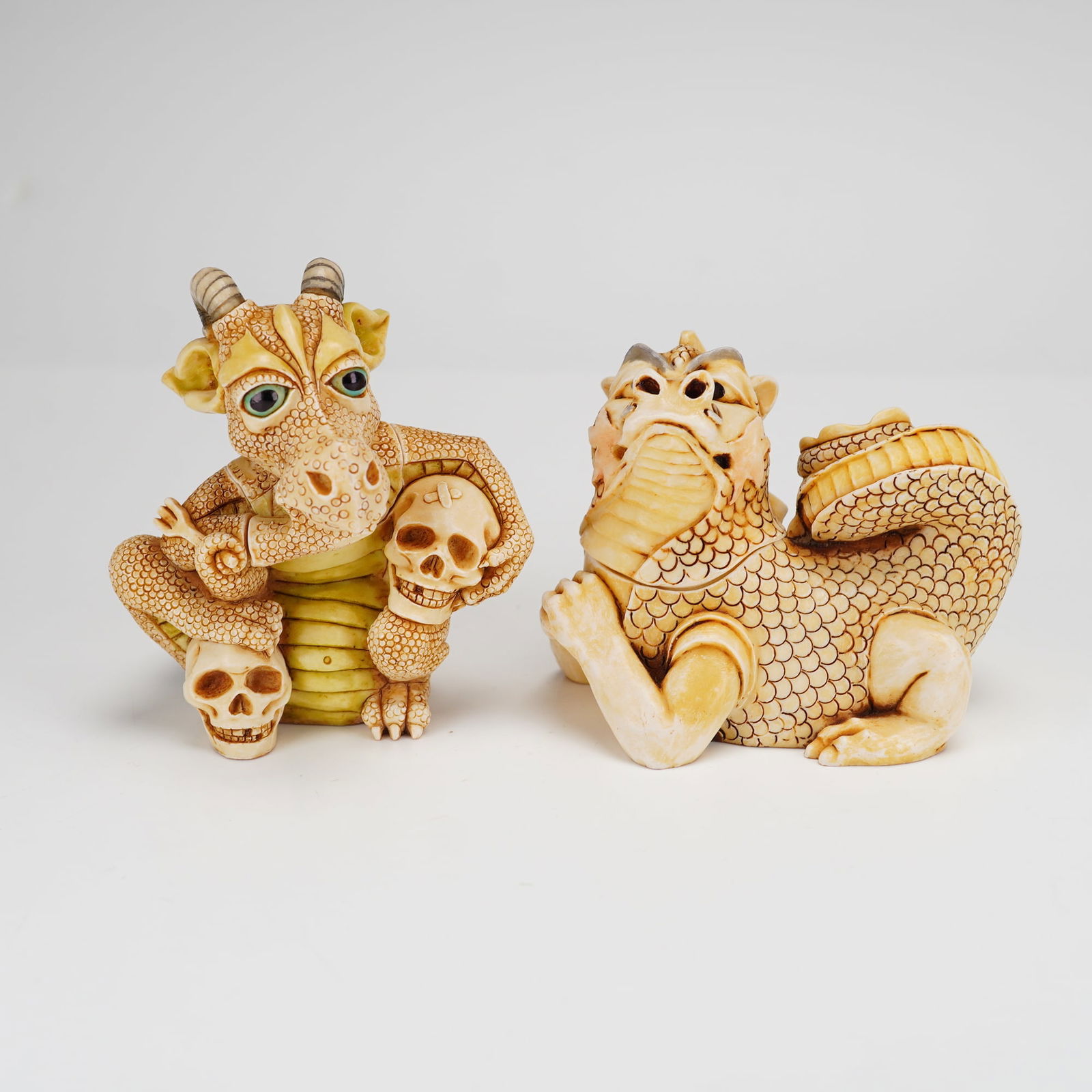 2pc Harmony Kingdom Trinket Boxes Grisaille and Cadmius: Two Harmony Kingdom marble resin trinket boxes titled Grisaille and Cadmius. These box figurines, copyrighted in 2002 and made in England, are finished in an antiqued ivory tone. The Grisaille figurin