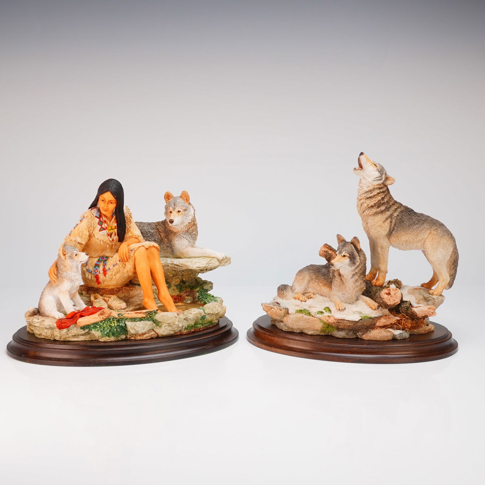 2pc Country Artist Sculptures affixed to Wood Bases: A pair of hand-painted resin sculptures by Country Artists, each mounted on a polished oval wooden base. The first figurine, titled Little Spirit, is a limited edition work by artist Keith Sherwin, nu