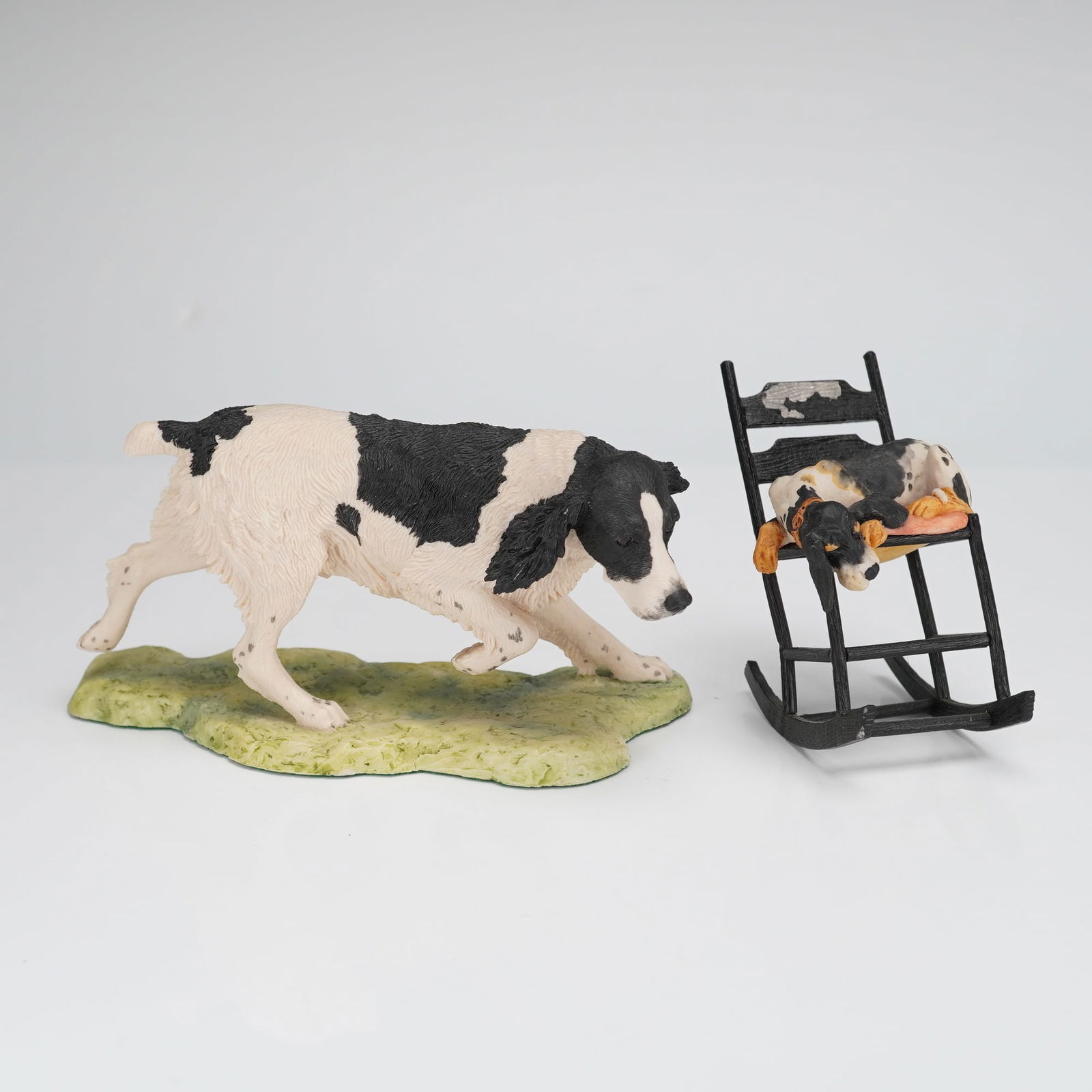2pc Border Fine Arts Dog Figurines: A group of hand-painted figural sculptures featuring dog subjects. The first item is a large figurine depicting a black and white English Springer Spaniel sculpted in a running or stalking pose, mount