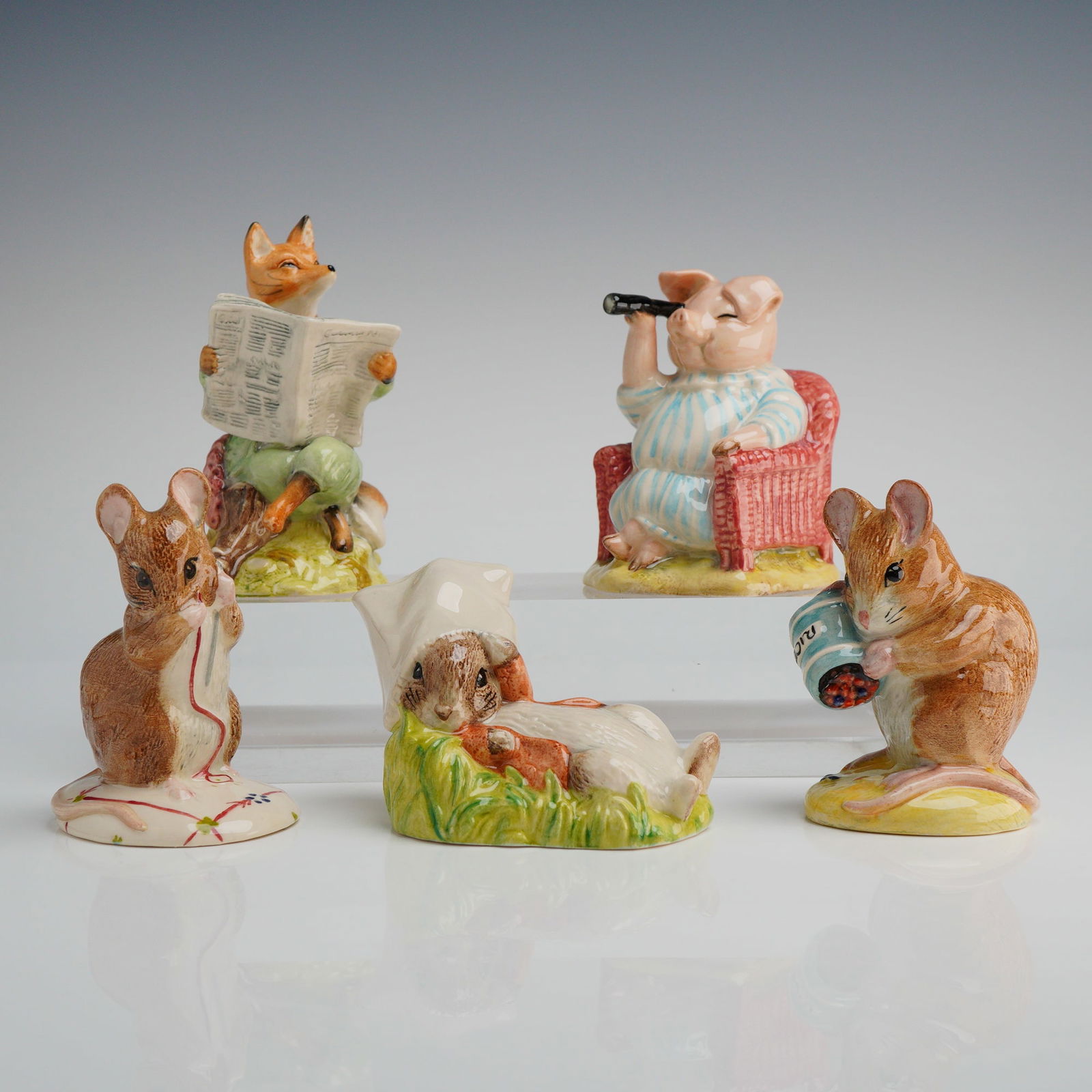Collection of 5 Royal Albert Beatrix Potter Figurines: A collection of five hand-painted glazed ceramic figurines manufactured by Royal Albert for The World of Beatrix Potter collection. The pieces depict anthropomorphic animal characters from the