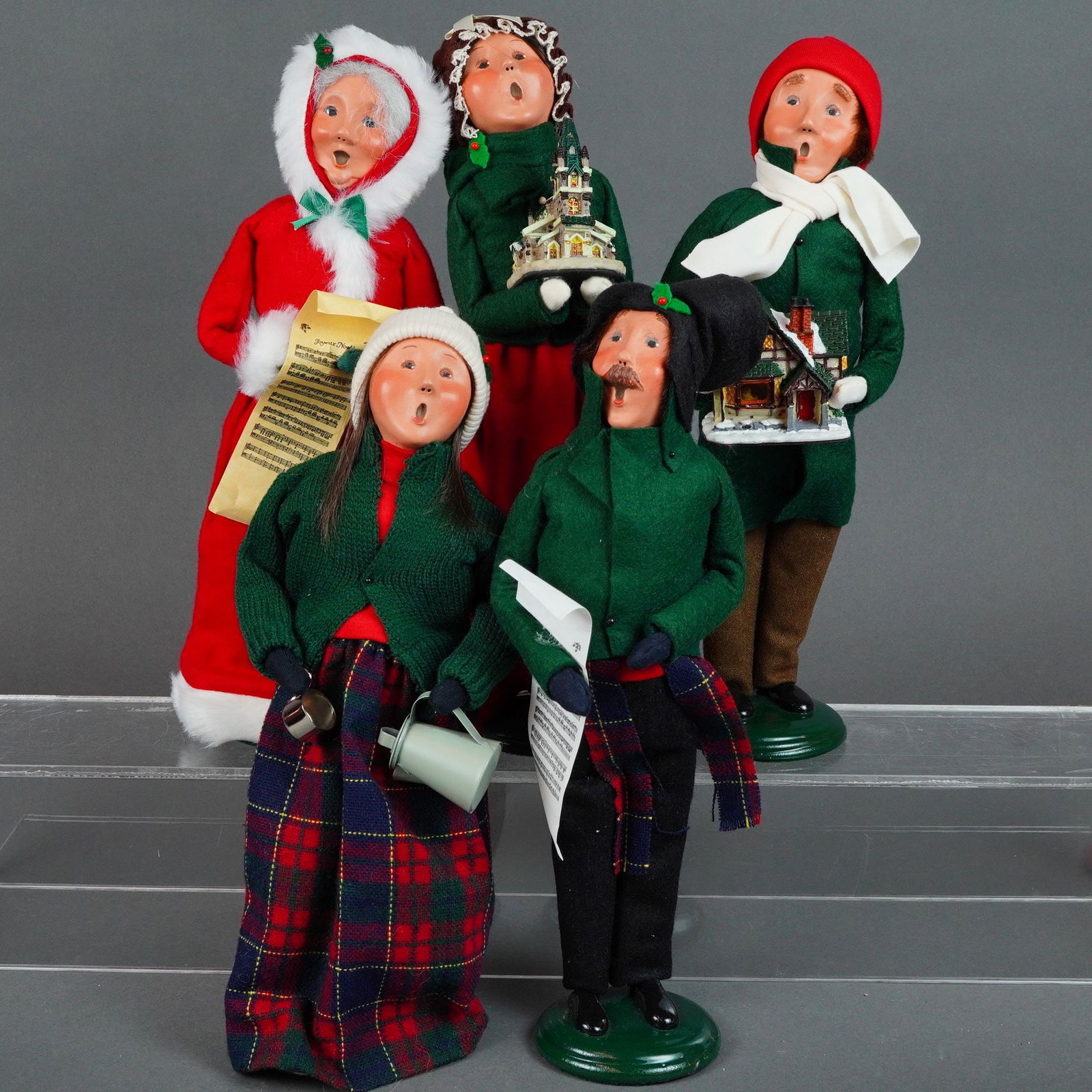 5pc Byers' Choice Ltfd. The Carolers Figurines: Dolls handcrafted in Chalfont, PA. feature traditional Dickensian-style winter attire constructed from felt, knit, and plaid fabrics. Each figure is designed with a molded, hand-painted face