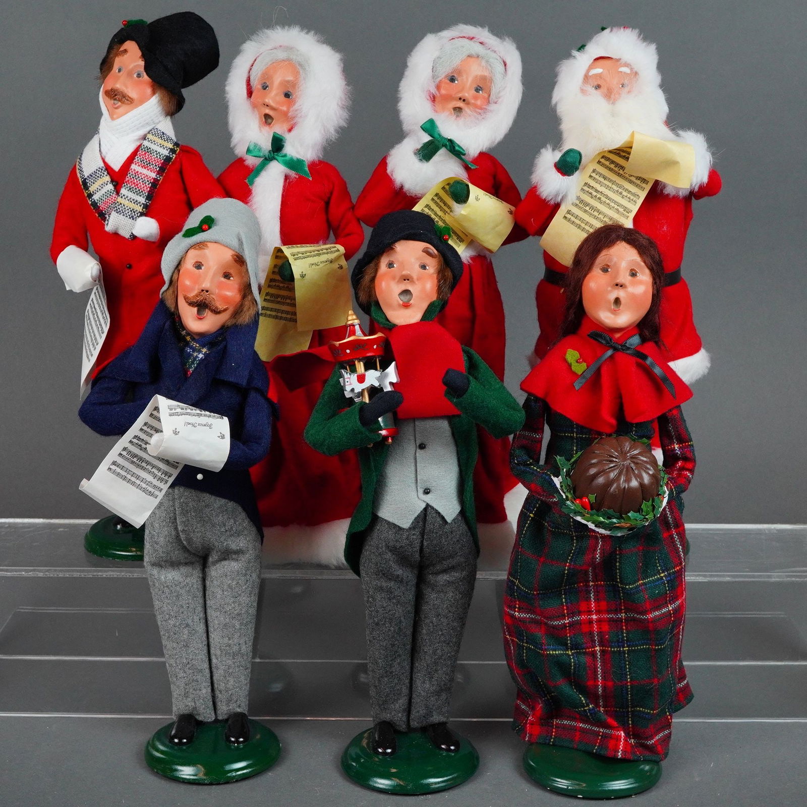 7pc Byers' Choice Ltd. The Carolers Figurines: Handcrafted in Chalfont, PA. these figurines are constructed with wire armatures and feature hand-painted faces with characteristic open mouths. The figures are dressed in various Victorian-style