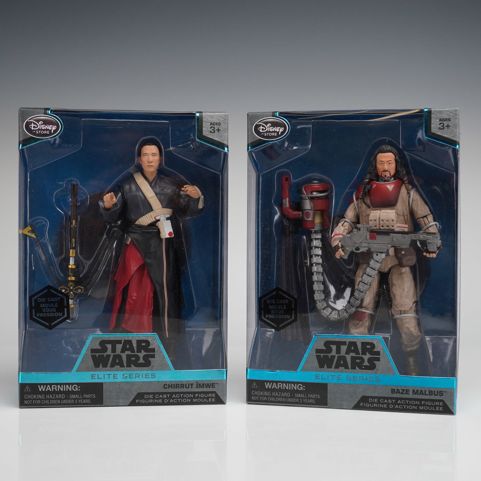 2pc Star Wars Elite Series Chirrut and Baze Figures: Two Star Wars Elite Series die-cast action figurines, featuring the characters Chirrut Imwe and Baze Malbus produced for the Disney Store and are presented new and sealed in their original packaging.