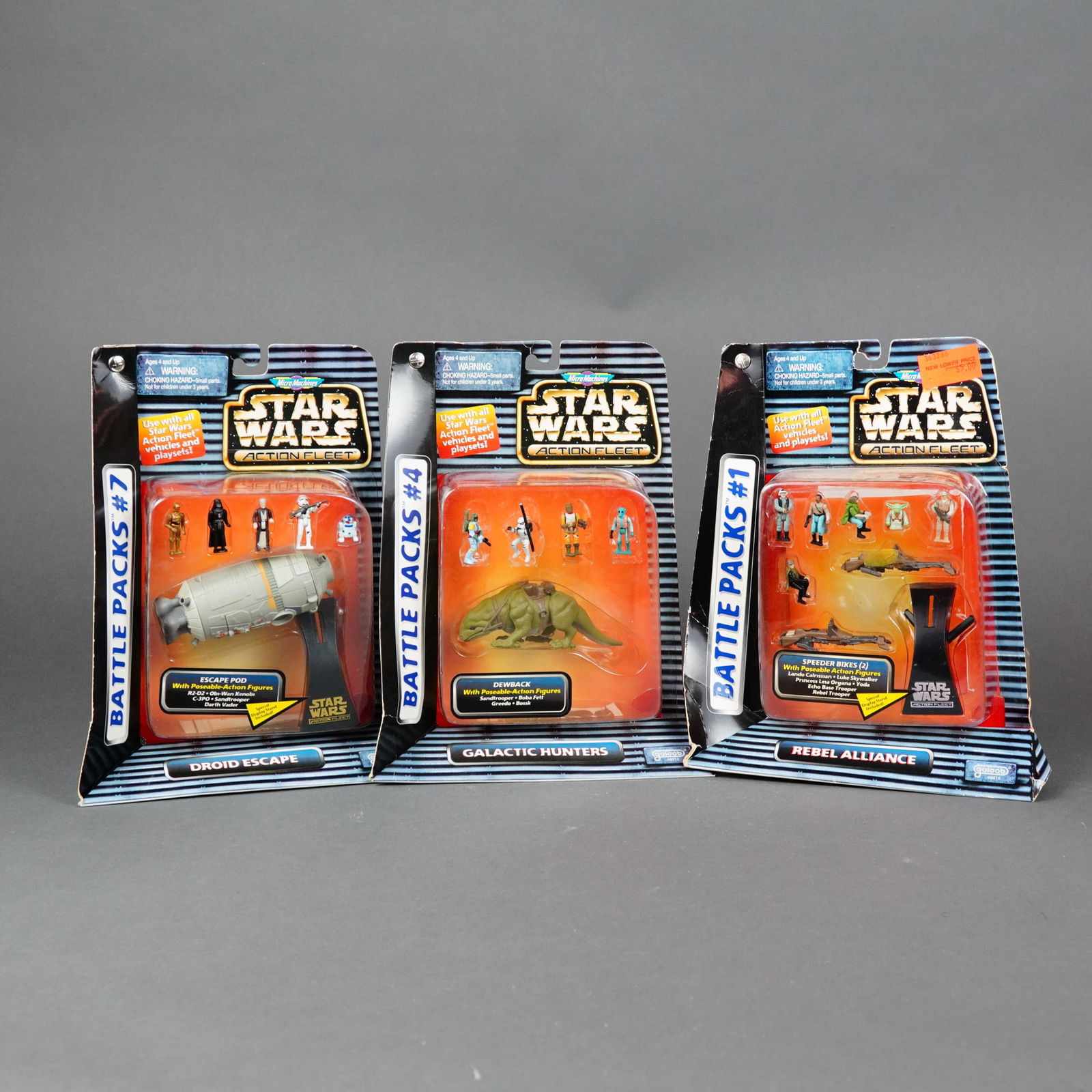Three Galoob Star Wars Micro Machines Action Fleet Battle Packs, 1996: Produced by Galoob Toys, Inc., this lot features three vintage Star Wars Action Fleet Battle Packs from 1996. The collection includes Battle Pack #1 Rebel Alliance, Battle Pack #4 Galactic Hunters,