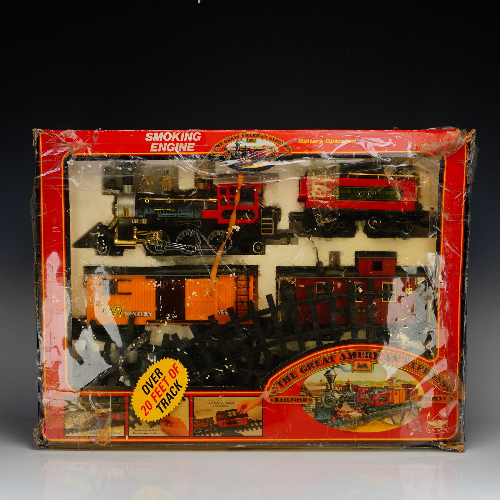 New Bright The Great American Express Smoking Engine Train Set: Battery-operated model train set by New Bright featuring The Great American Express theme. Includes steam-style locomotive with tender and freight car, finished in black and red with gold-tone
