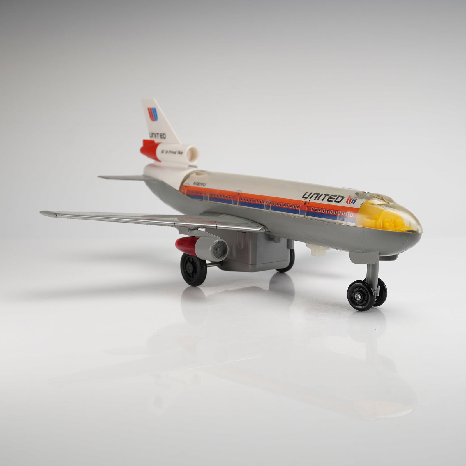 McDonnell Douglas DC-10 Friend Ship United Airlines Toy Plane: Battery Powered McDonnell Douglas DC-10 Toy Plane and its original accompanying packaging box. The plastic toy is modeled after the United Airlines "Friendship" livery, featuring a grey fuselage,