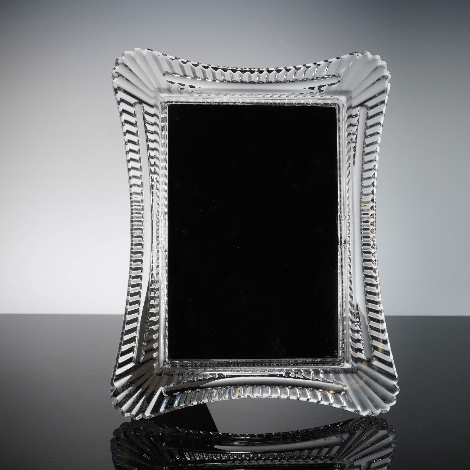 Waterford "Abbeville" Lead Crystal Picture Frame: A fine lead crystal picture frame by Waterford in the "Abbeville" pattern. This rectangular frame features elegant concave sides and a sophisticated cutting design characteristic of high-quality Irish