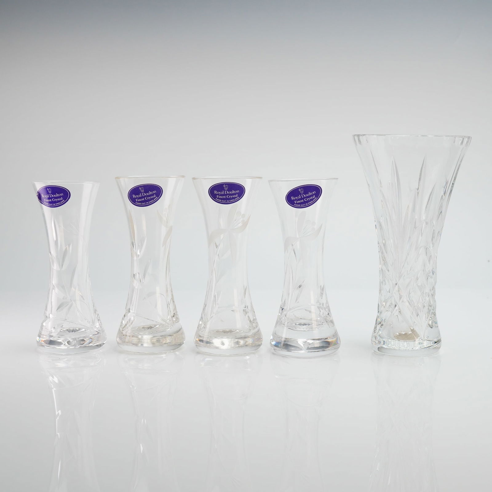 5pc Royal Doulton Crystal Vases: A collection of five Royal Doulton hand-cut lead crystal vases, comprising one large Pegasus Hollow Sided Vase and four smaller Chloe Hollow Sided Vases. Each piece is constructed from lead crystal an
