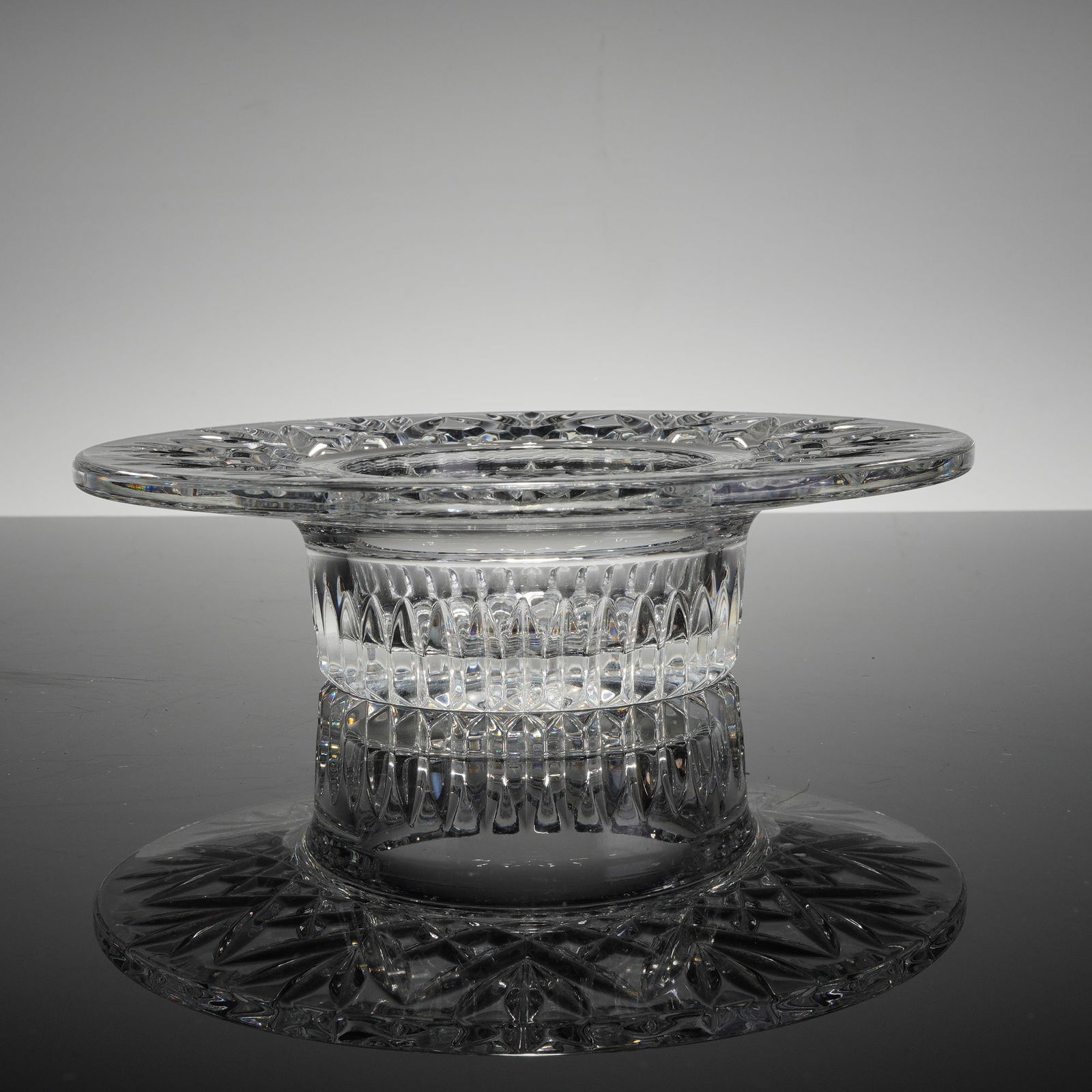 Waterford Crystal Bethany Pillar Candleholder: This Waterford crystal pillar candleholder is a fine example of high-quality Irish lead crystal in the Bethany pattern. The piece features a wide, flat rim with a recessed central well designed to acc