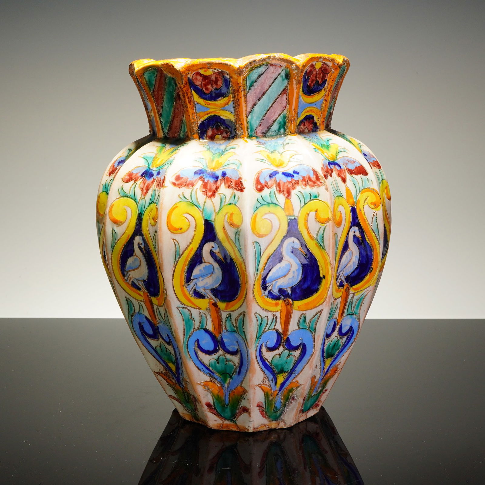 Maiolica Hand-Painted Ceramic Vase with Birds & Floral Motifs: The earthenware vessel is constructed with a bulbous, fluted, and lobed body terminating in a flared, scalloped rim. The hand-painted decoration is organized into vertical registers, with the primary