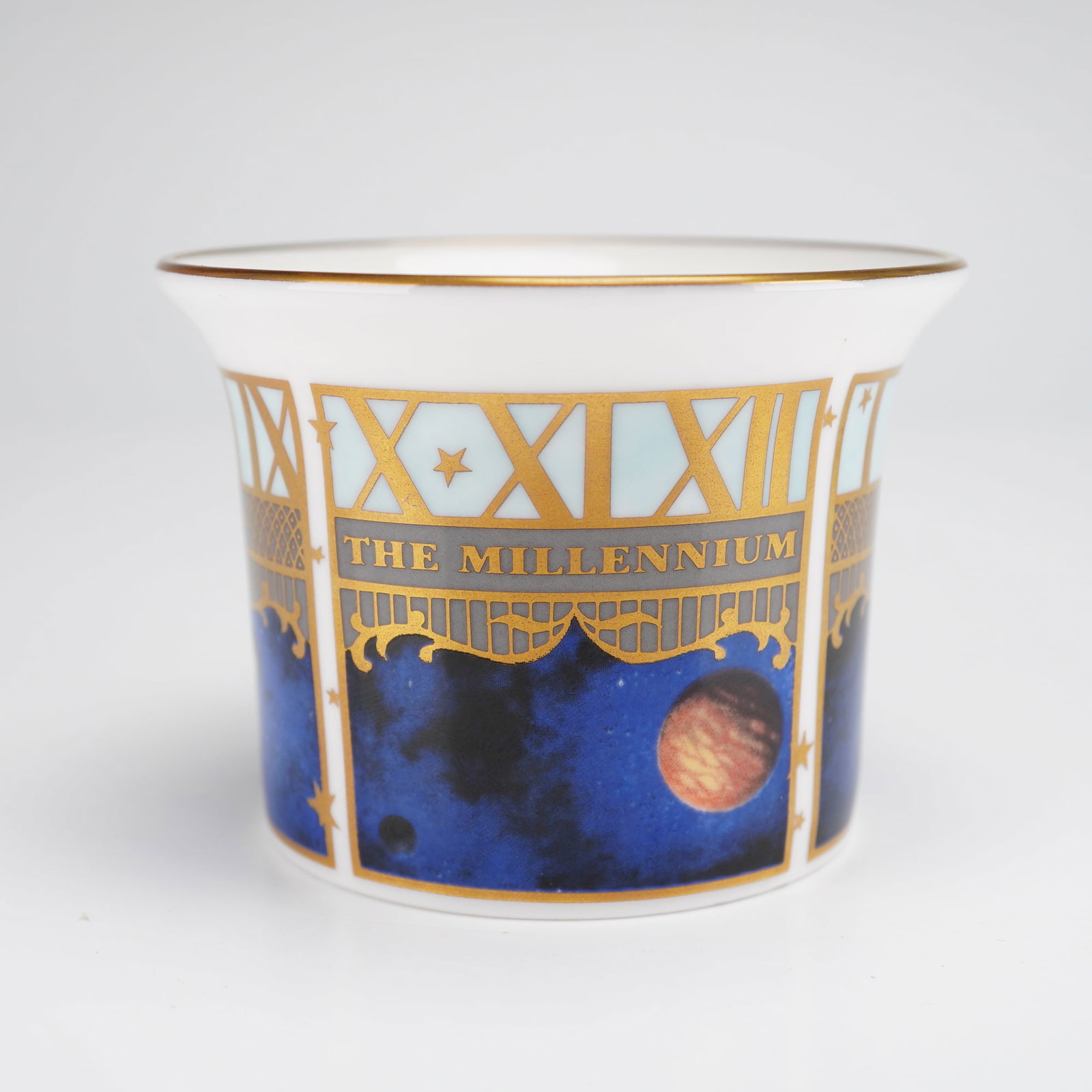 Royal Worcester Millennium Votive Candle Holder: Royal Worcester bone china votive candle holder produced to celebrate the millennium. This piece, which can also serve as a commemorative cup or beaker, features a flared rim and celestial-themed