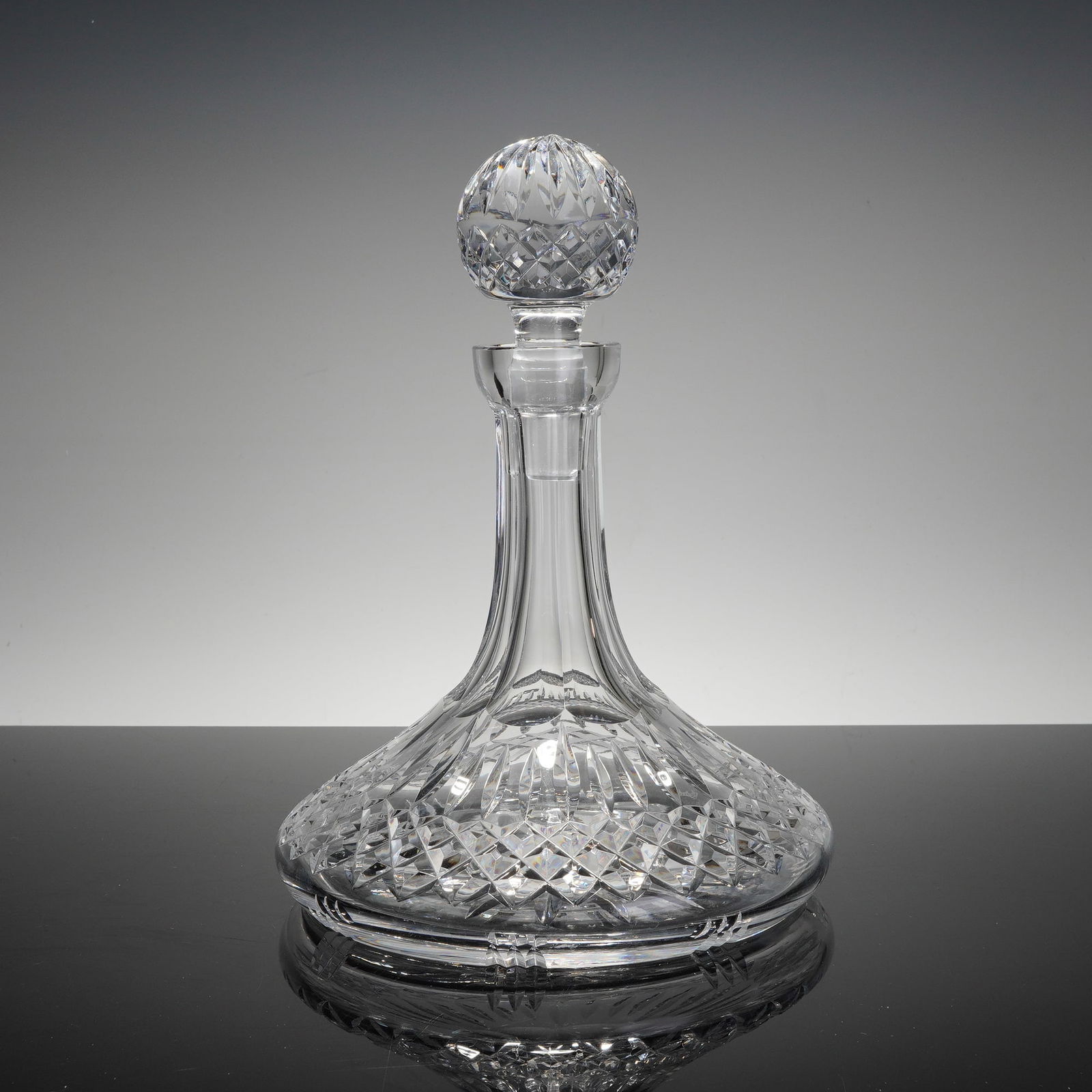 Waterford Lismore Ships Decanter: This is a fine Waterford lead crystal ships decanter in the iconic Lismore pattern. Originating from Ireland, the piece features the classic broad, stable base designed for maritime use. The body is d