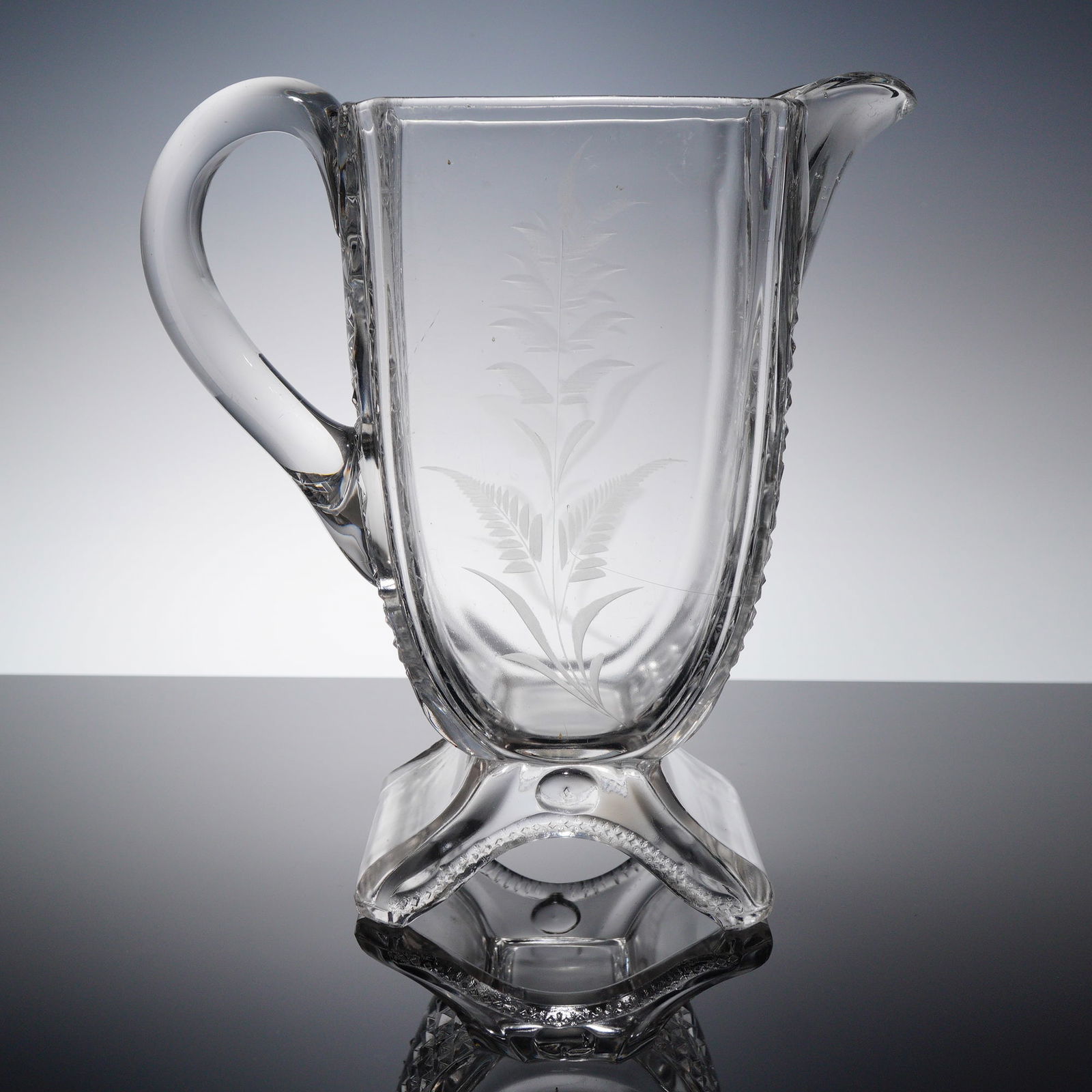 EAPG Square Pressed Glass Pitcher with Etched Floral Motif: This vintage square pressed glass pitcher features flat sides and a detailed etched floral design. It is a classic example of mid-19th to early 20th-century American pressed glassware, often produced