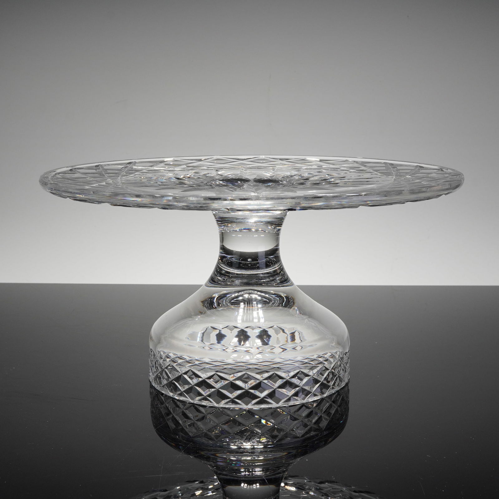 Waterford Comeragh Crystal Pedestal Cake Stand: This is a fine example of Waterford hand-cut lead crystal in the classic Comeragh pattern. The pedestal cake stand, or tazza, features a flat, circular top decorated with a deeply cut 16-point central