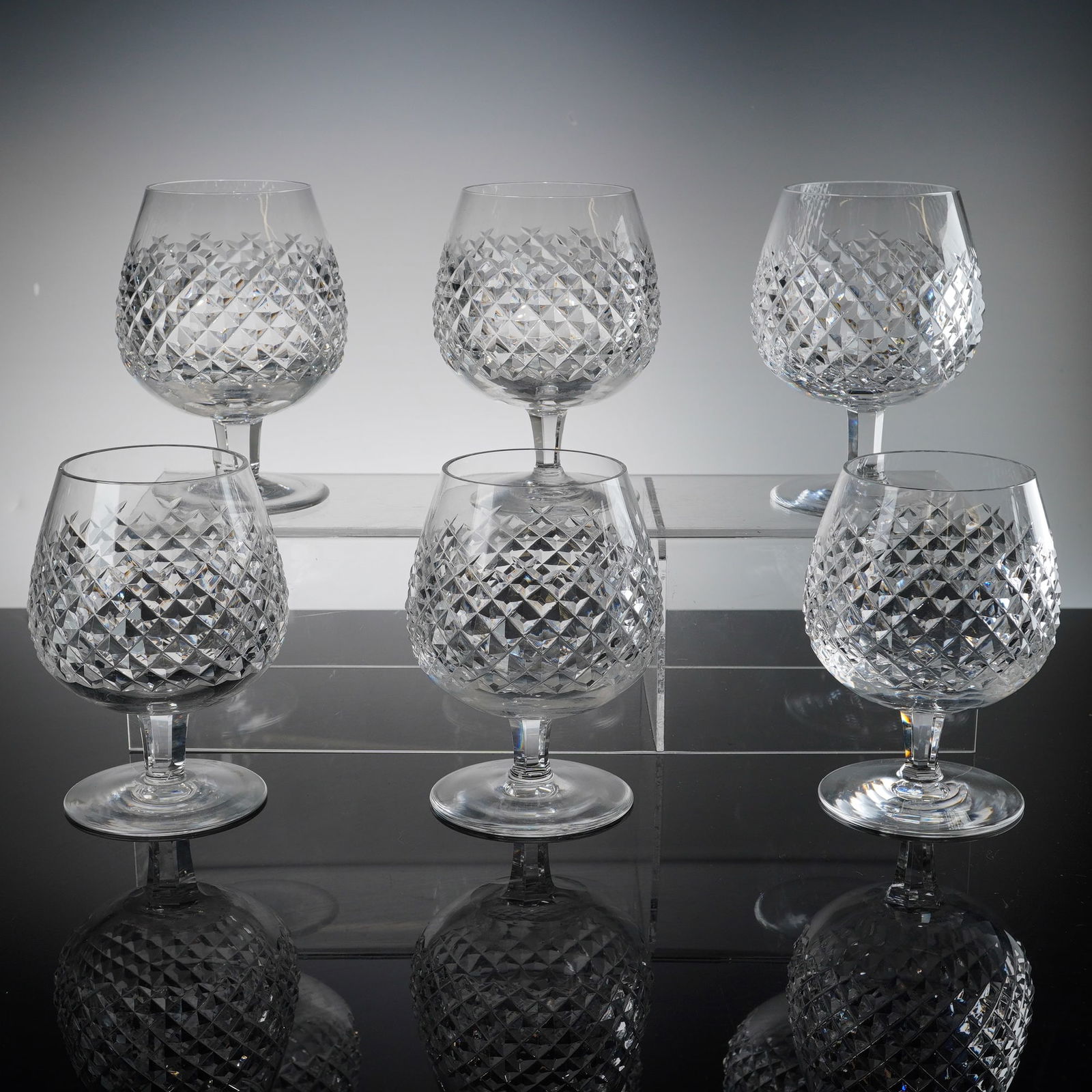 Waterford Alana Pattern Crystal Brandy Snifters, Set of Six: This set of six brandy snifters is crafted from premium lead crystal by the renowned Irish manufacturer, Waterford. Each glass features the iconic Alana pattern, characterized by a sophisticated
