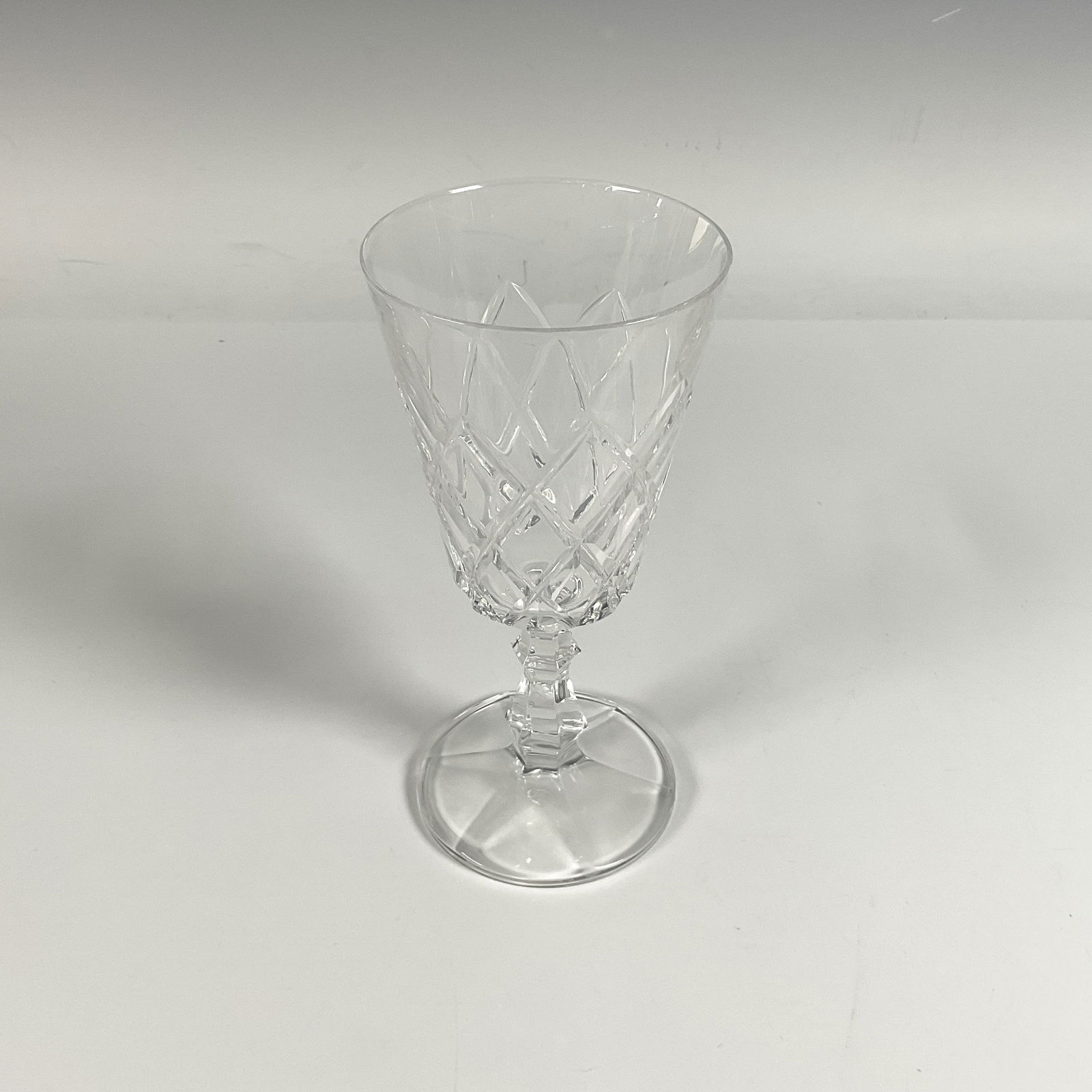 Crystal Wine glass: Exquisite Irish crystal glassware featuring intricate and elegant patterns, including dazzling diamond and star shaped cuts. Unmarked. Dimensions3.5"L x 6.75"H
