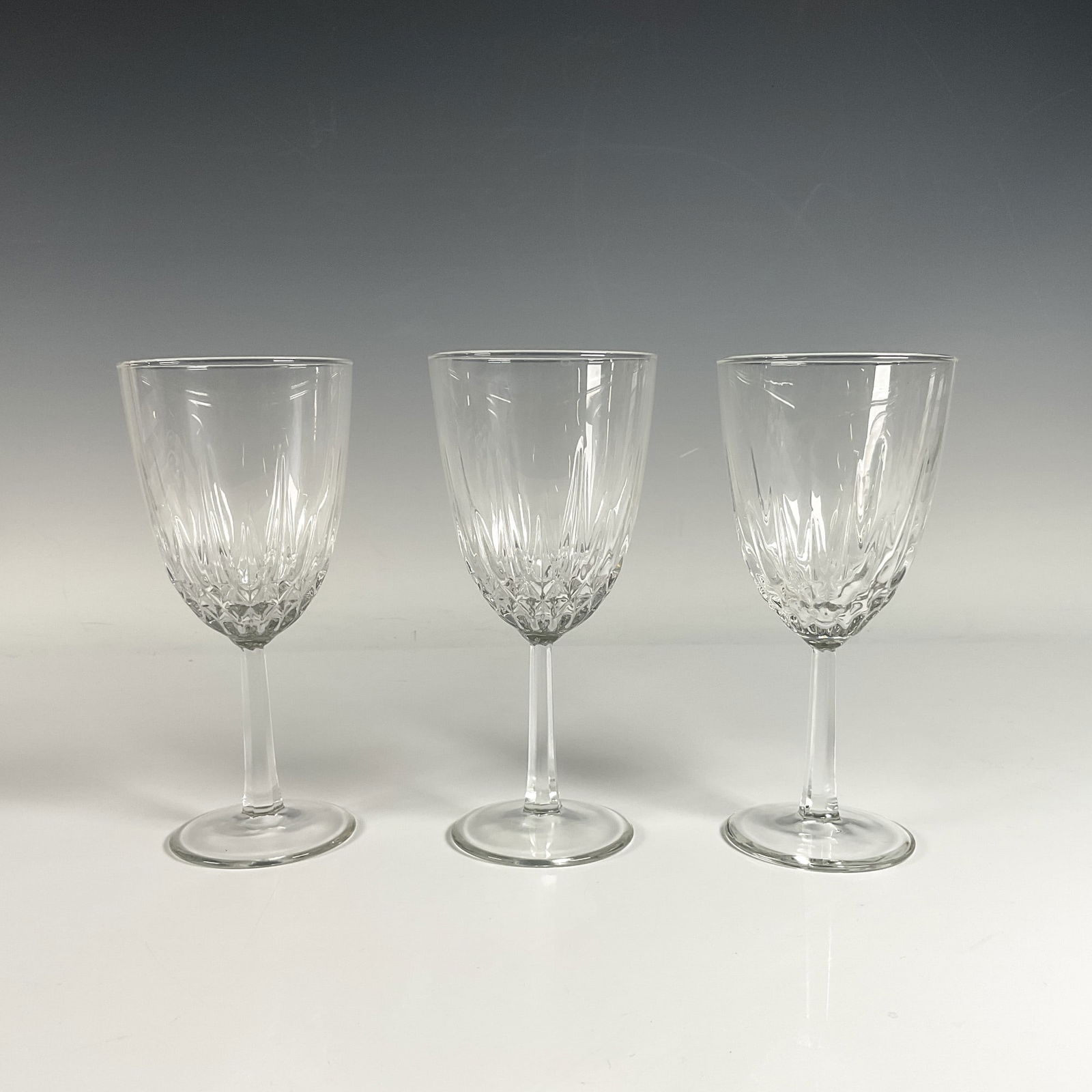 3pc Wine Glasses: Sparkling, brilliant glass featuring intricate diamond shaped cuts and faceted patterns, designed to reflect light with exceptional clarity. Unmarked. Dimensions3.25"W x 7.25"H
