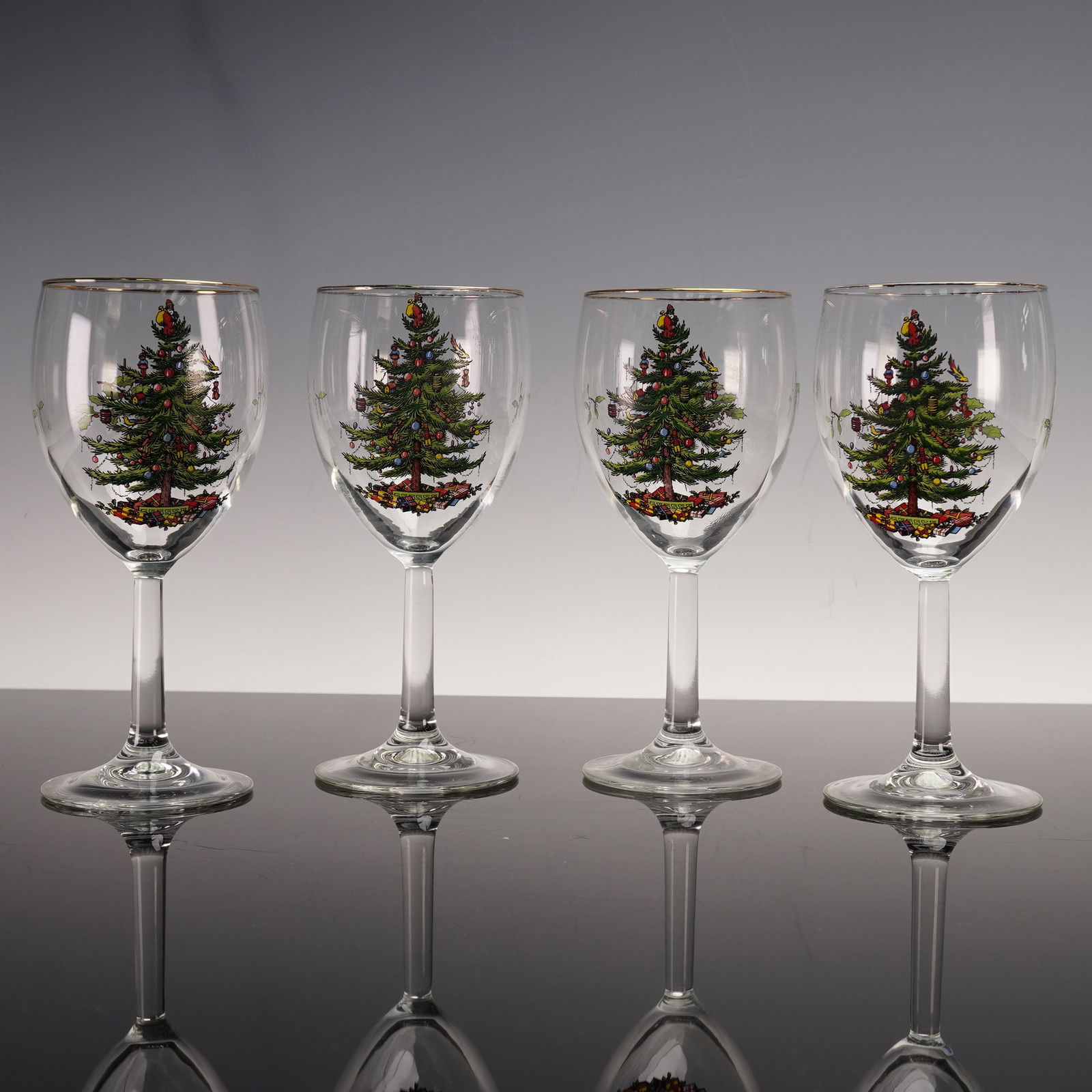 4pc Salem Wine Glasses, Christmas Eve: Set of four Salem glass wine goblets decorated with the Christmas Eve pattern, featuring a festive Christmas tree design and gold rim accents. Dimensions7.25"H Date or Era20th century