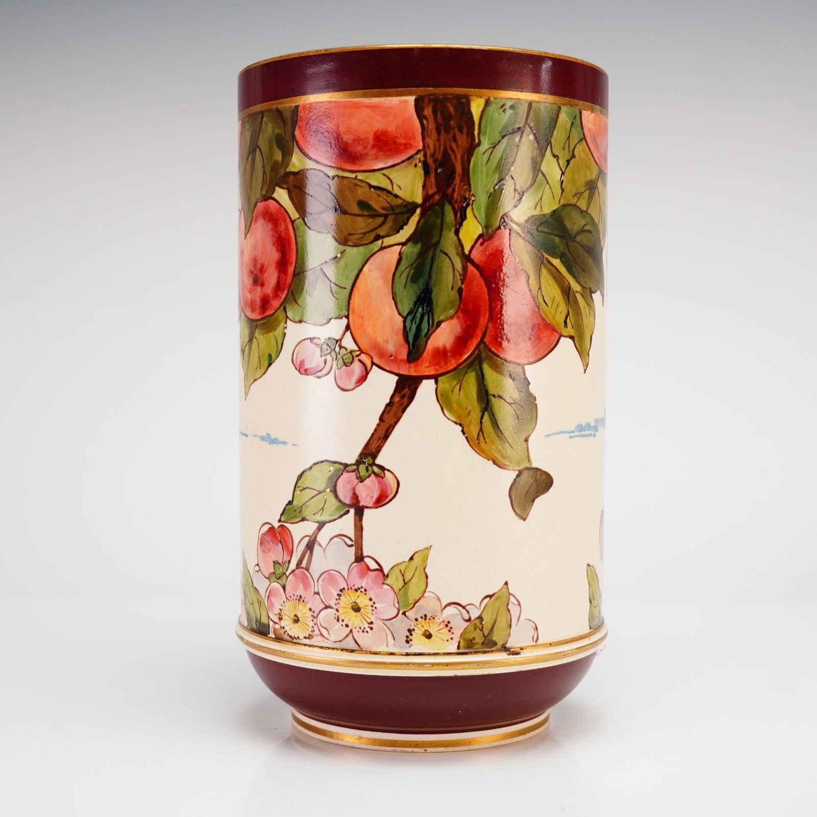 Wedgwood Creamware Vase with Enamel Fruit Motif, c. 1880: This cylindrical Wedgwood creamware vase features a botanical enamel fruit motif depicting peaches on fruit-laden branches, dating to circa 1880. The decoration includes green leaves and pink blossoms