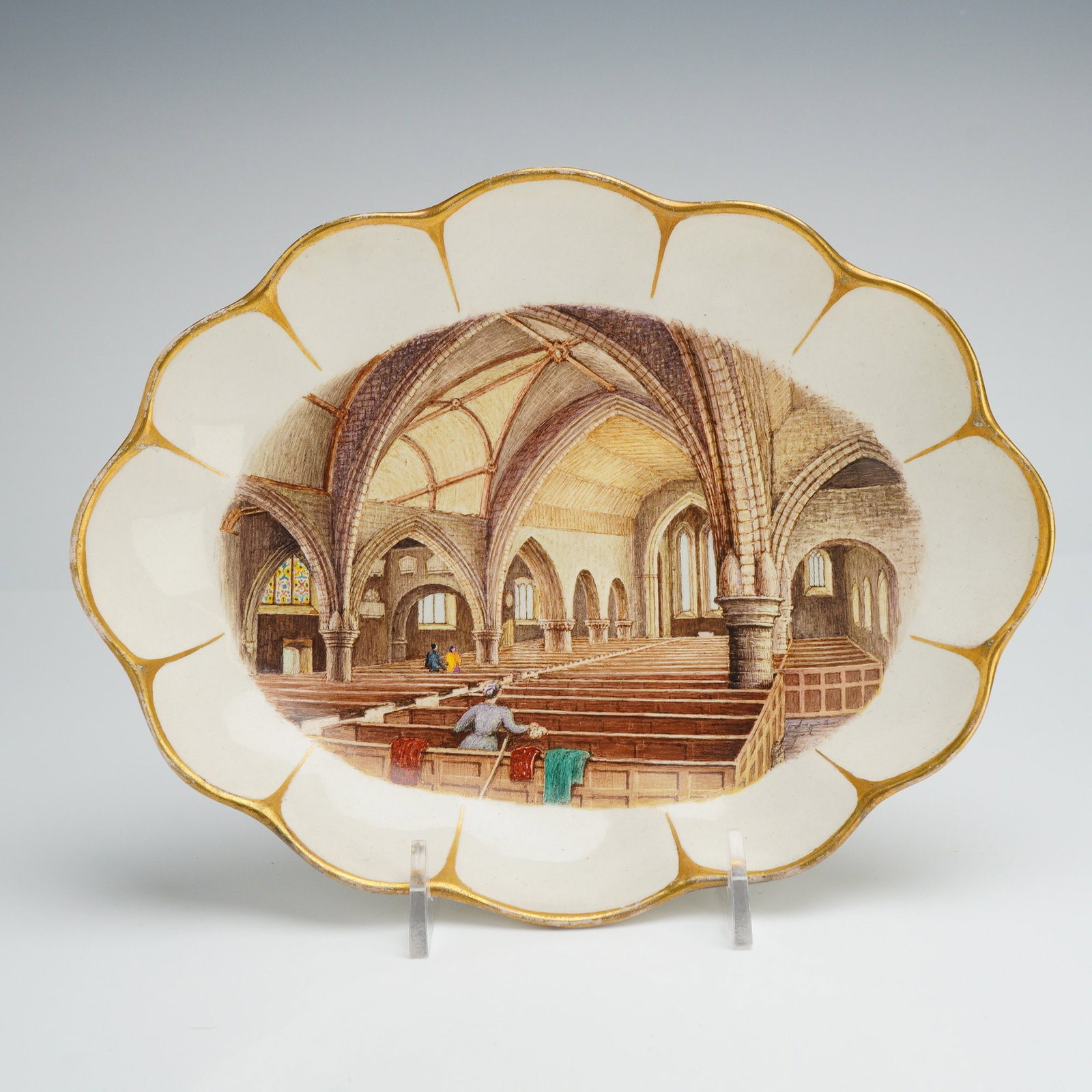 Victorian Wedgwood Creamware Decorative Plate, Milford Church: A Victorian Wedgwood creamware oval dish featuring a lobed, scalloped rim accented with gilded petal-like motifs. The center is finely decorated with a hand-painted topographical architectural interio