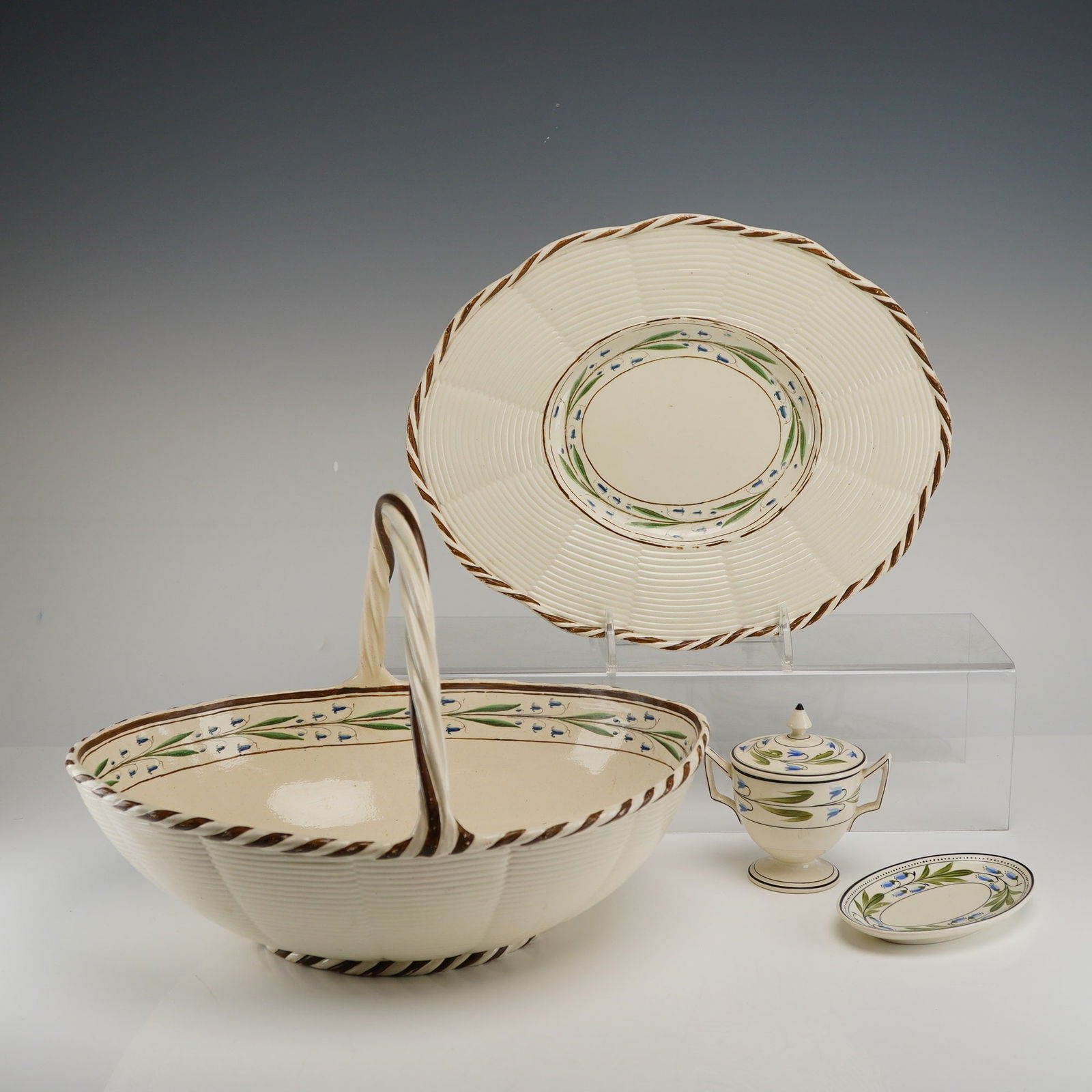 Wedgwood Blue Flower Pattern Creamware Tableware: This group of Wedgwood creamware, also known as Queen's Ware, dates to the English Regency period, circa 1800-1820. The set features a hand-painted blue flower pattern, specifically harebells or blueb