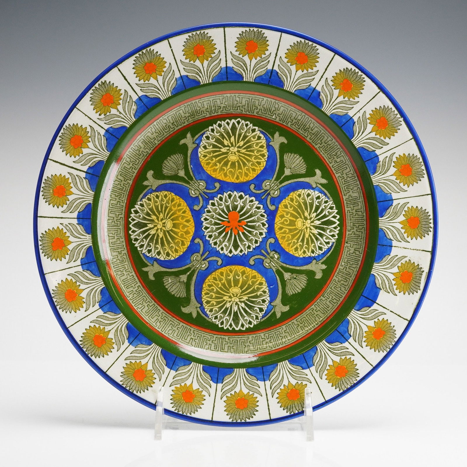 Wedgwood Creamware Plate, Marigold: The decoration is executed in polychrome enamel over a transfer-printed base. The design features bold colors, predominantly green, blue, yellow, and orange, executing complex geometric and stylized m