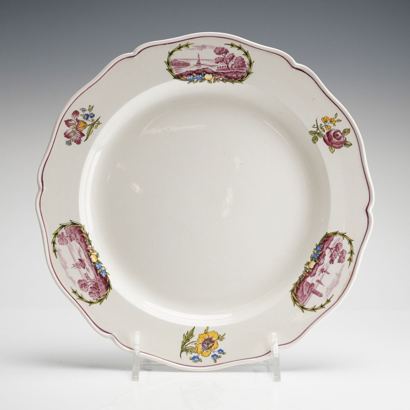 Wedgwood Etruria Creamware Plate, Clericy: The plate features a scalloped rim and a wide cavetto. The surface is decorated with transfer-printed reddish-purple designs showing alternating scenic cartouches of ships on calm waters, separated by