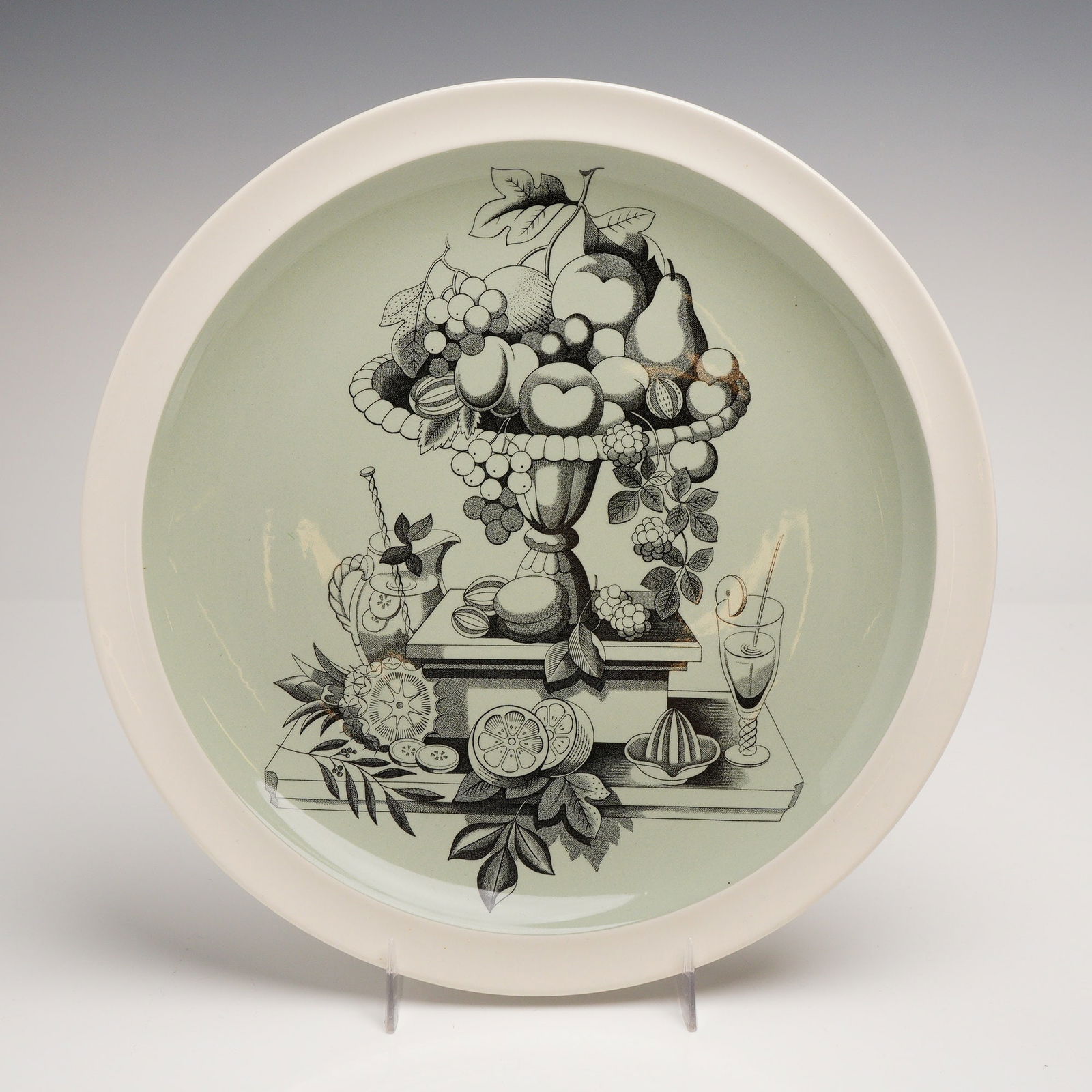 Wedgwood Fruit Still Life Trial Creamware Charger: A rare Wedgwood circular creamware charger featuring a sophisticated Mid-Century Modern transfer-printed design. The center displays a black and white still life depicting an arrangement of fruit in a