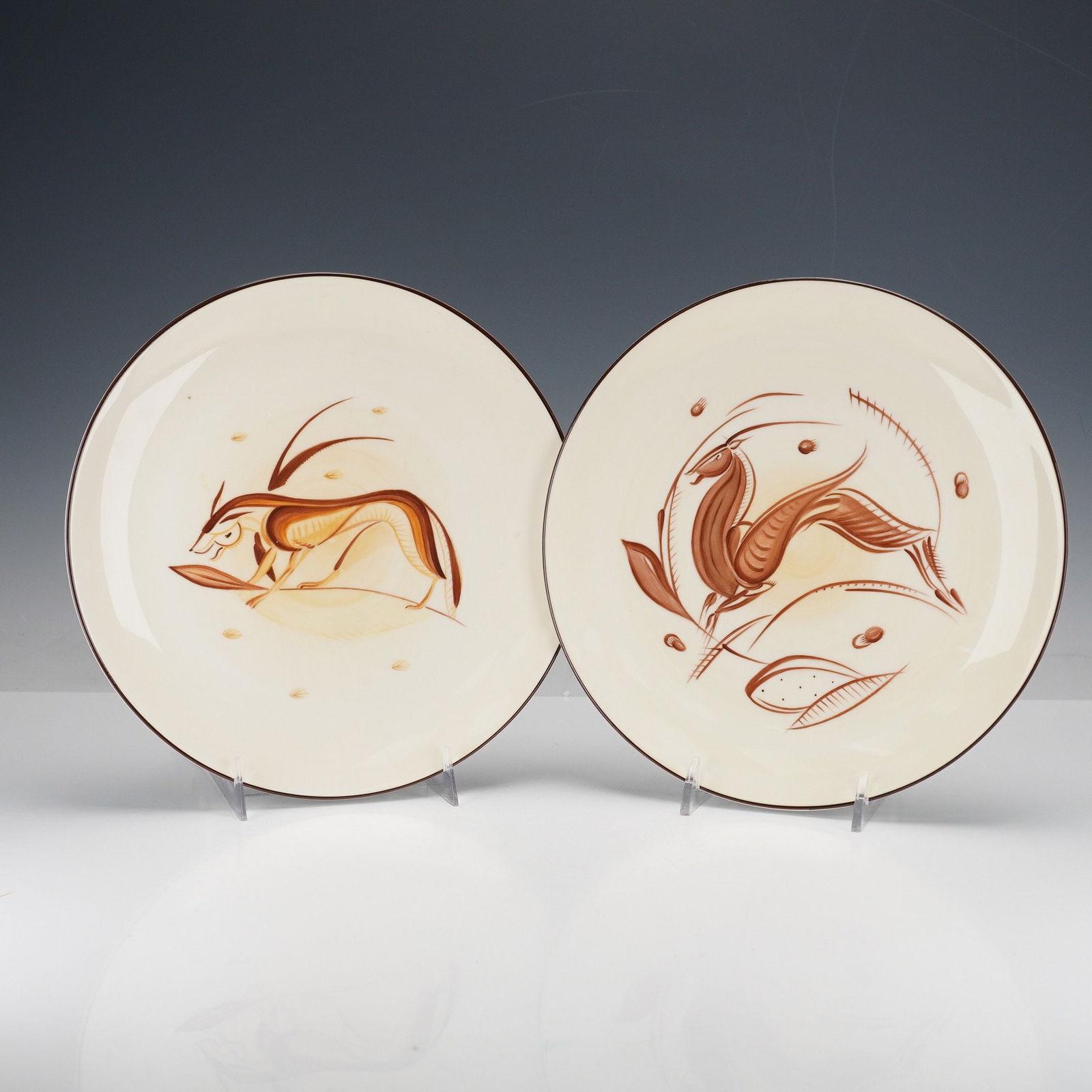 2 Wedgwood Bone China Plates, Antelope Motifs by J. R. French: A pair of Wedgwood Susie Cooper Style limited edition bone China plates, hand-painted by J. R. French in 2002 at the Wedgwood Visitor Centre. Each plate features a stylized depiction of an antelope or