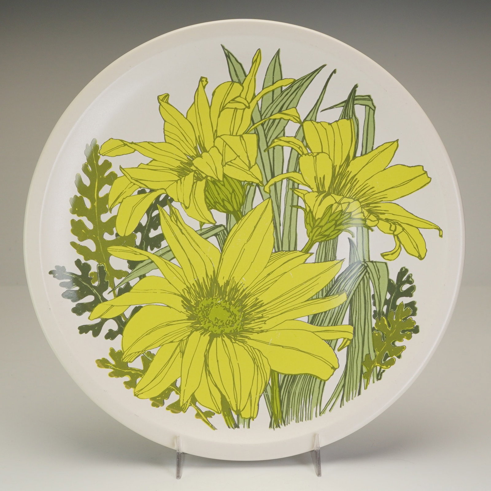 Wedgwood of Etruria & Barlaston Ironstone Dinner Plate, Riviera: This Wedgwood ironstone plate showcases the Riviera pattern, a vibrant modernist floral design featuring three large yellow composite flowers and stylized green foliage set against a white background.