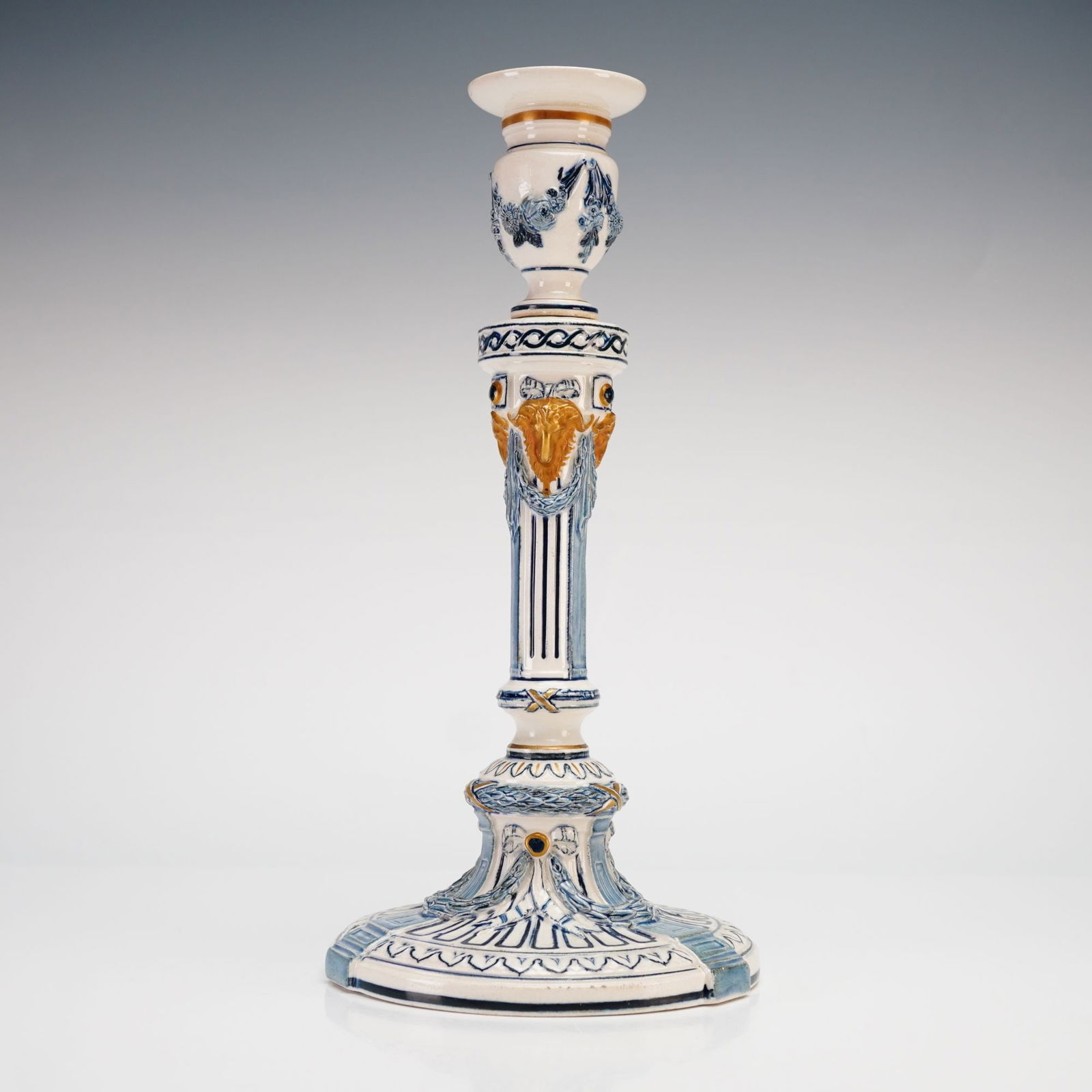 A Wedgwood Cinque Cento Ceramic Candlestick, circa 1870: A Wedgwood Cinque Cento ceramic candlestick, produced in the late 19th century. The piece is designed in the Neoclassical style, featuring a tapered and fluted column shaft decorated with relief-molde