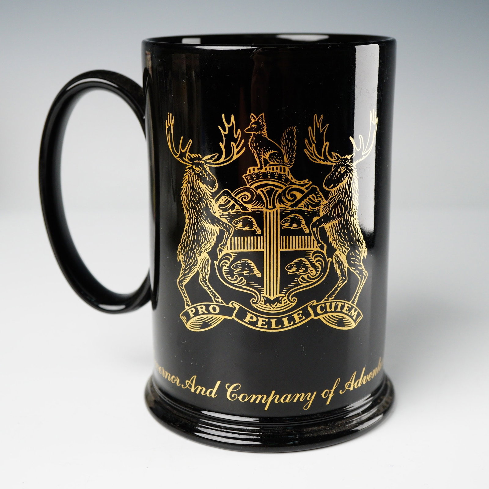 A Wedgwood Hudsons Bay Company 300th Anniversary Commemorative Mug: A Wedgwood commemorative mug designed specially for the Hudsons Bay Company 300th Anniversary (1670-1970). The mug is constructed from highly glazed black ceramic and decorated extensively with gilt t